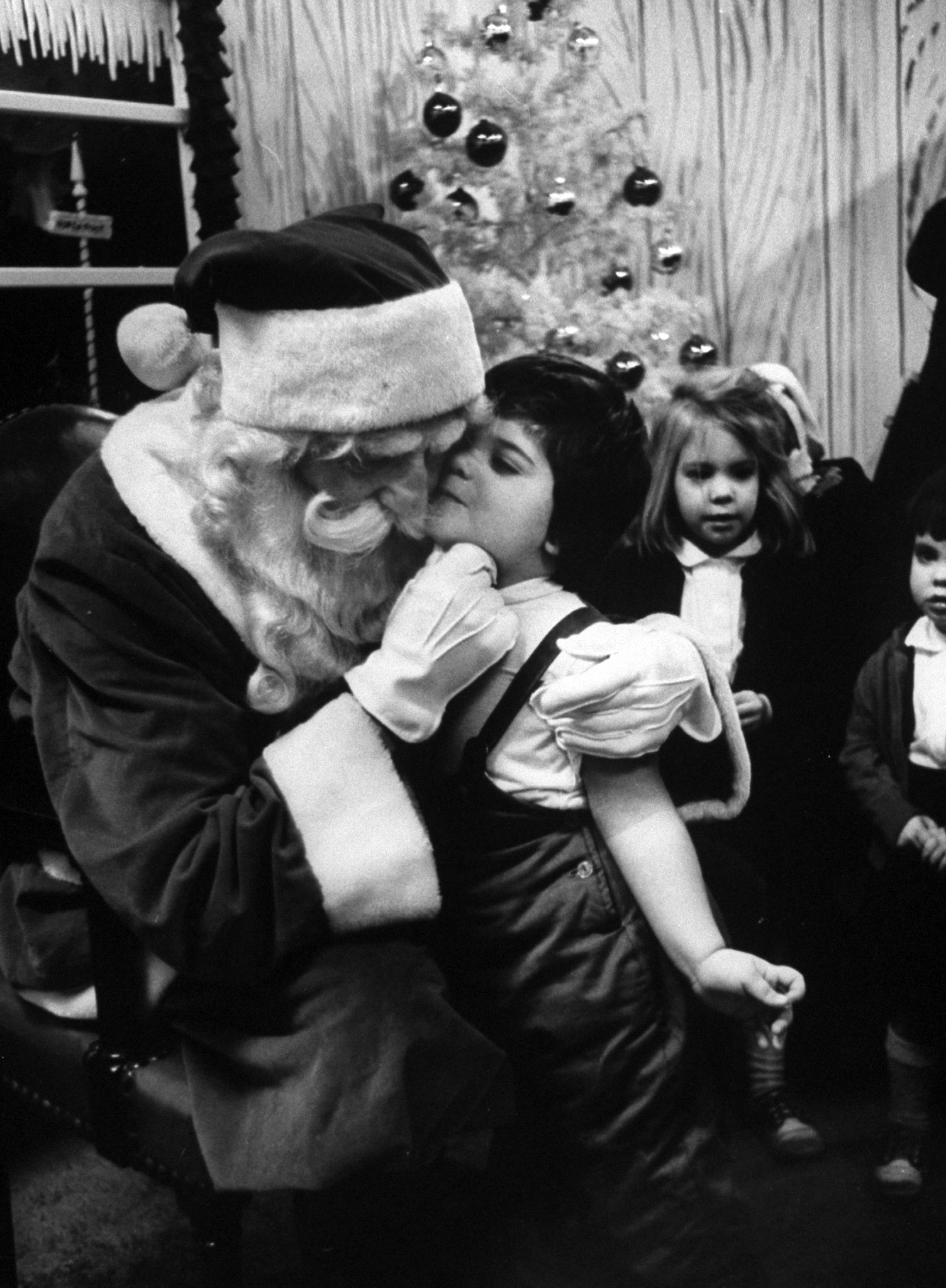 Little girl giving Santa Claus a kiss, 1962.