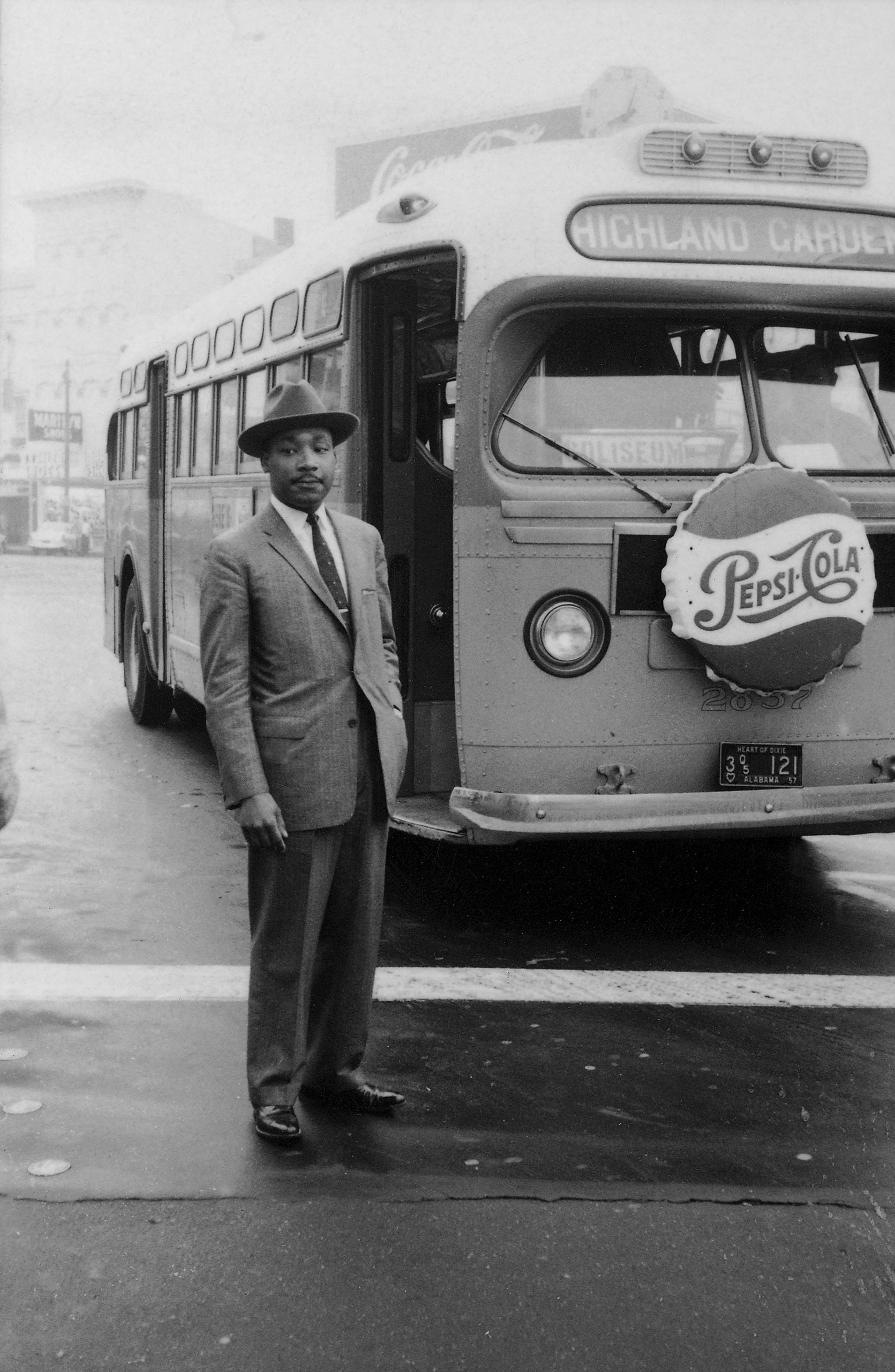 American Civil Rights leader Reverend Martin Luther King Jr. stands in front of a bus at the end of the Montgomery bus boycott, Montgomery, Alabama, December 26, 1956.