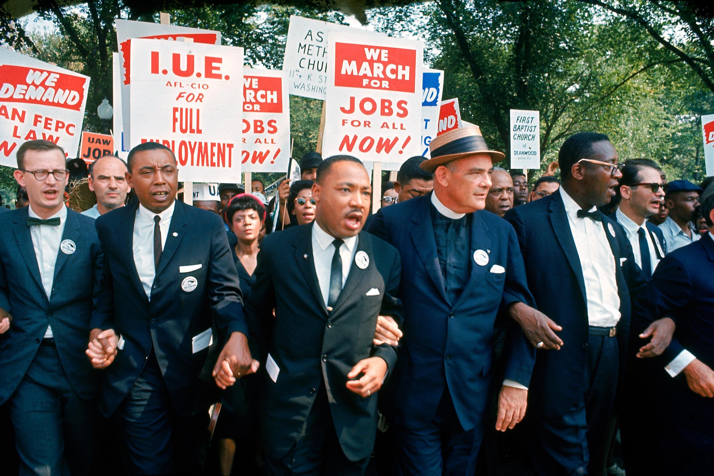 Leaders of March on Washington for Jobs and Freedom marching w. signs (R-L): Matthew Ahmann, Floyd McKissick, Martin Luther King Jr., Rev. Eugene Carson Blake and unidentified.