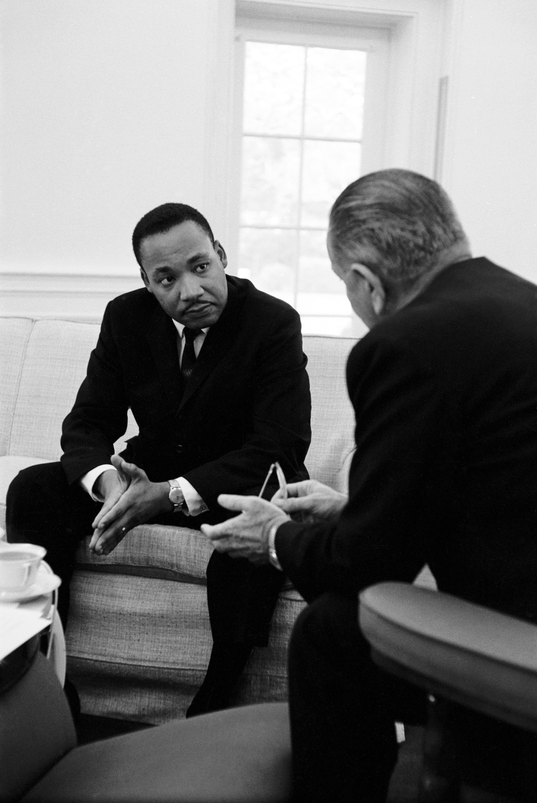 Civil rights leader Dr. Martin Luther King Jr.speaking with President Lyndon Johnson during a visit to the White House, 1963.