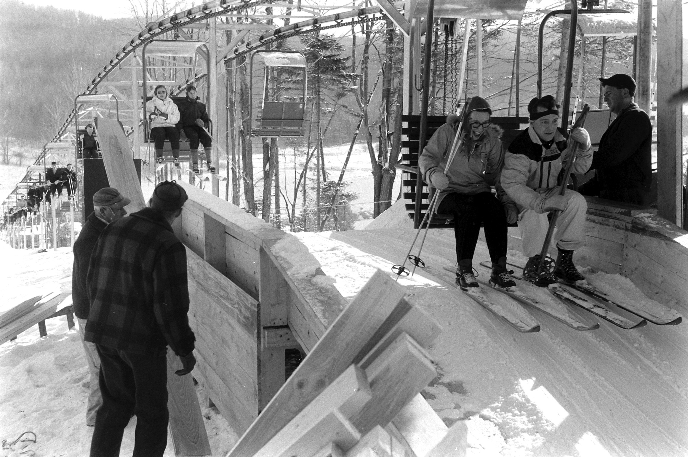 Double-chair life at Mt. Snow gives novices a luxury usually enjoyed only by crack skiers. Rushed carpenters finish their work after it goes into use.