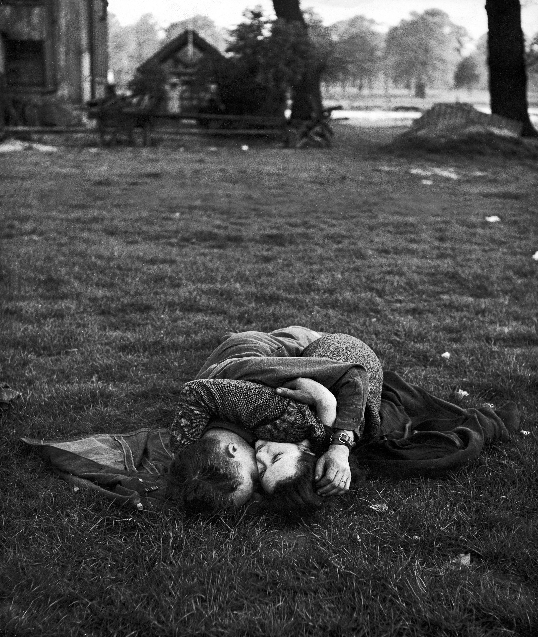 American soldier kissing his English girlfriend on lawn in Hyde Park, one of the favorite haunts of US troops stationed in England.