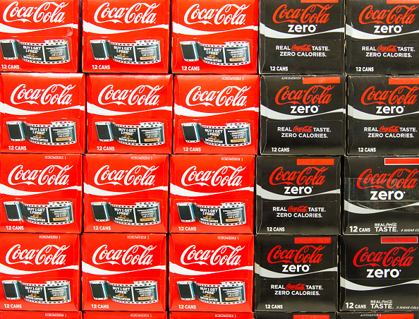 Stacks Coca Cola Zero and Coca Cola Diet can boxes in a store, Coca-Cola is a carbonated soft drink sold in stores, restaurants, and vending machines throughout the world (Roberto Machado Noa—LightRocket/Getty Images)