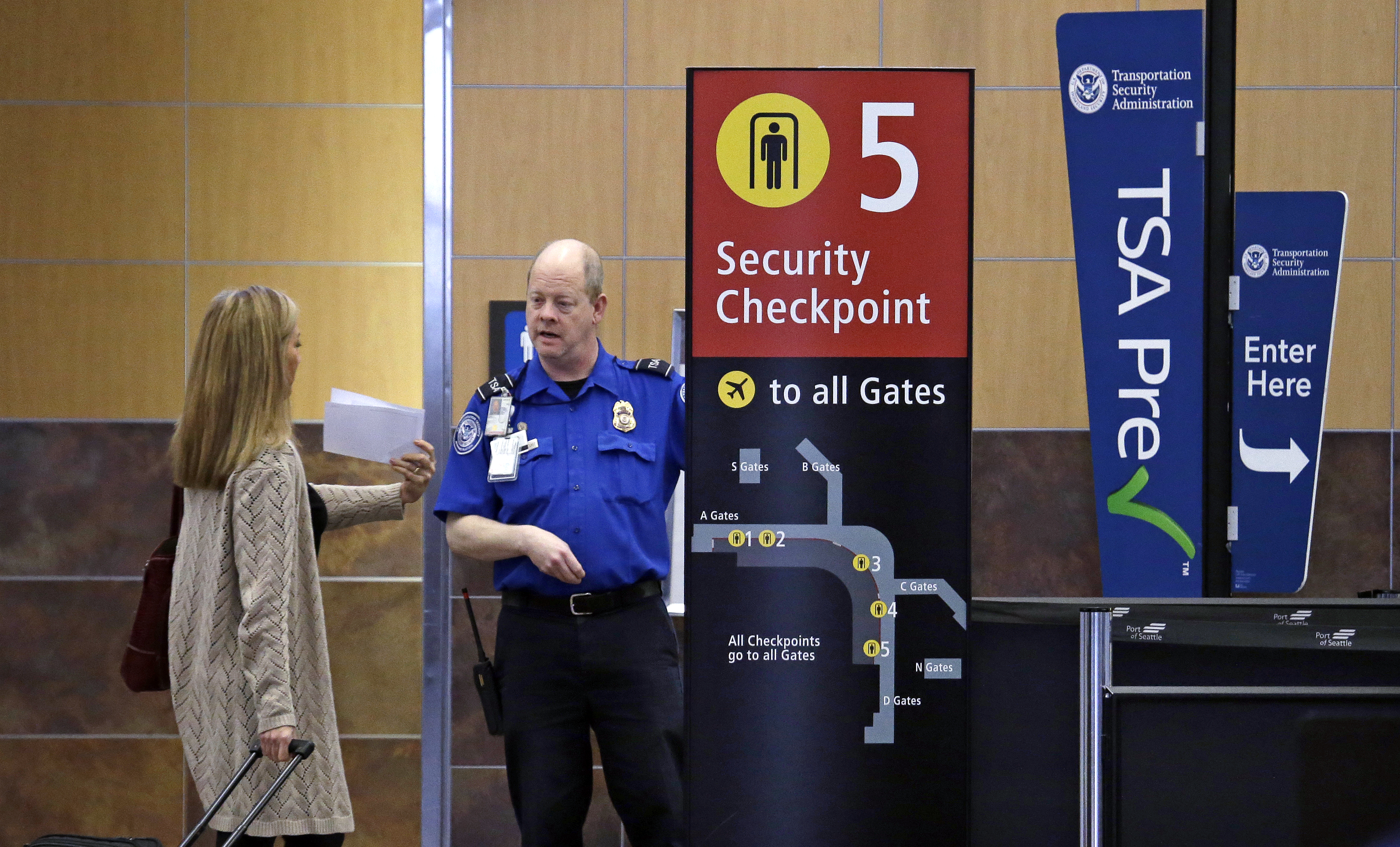 A passenger shows a boarding pass to a TSA agent at a security check-point at Seattle-Tacoma International Airport in SeaTac, Wash, March 24, 2015. (Elaine Thompson—AP)