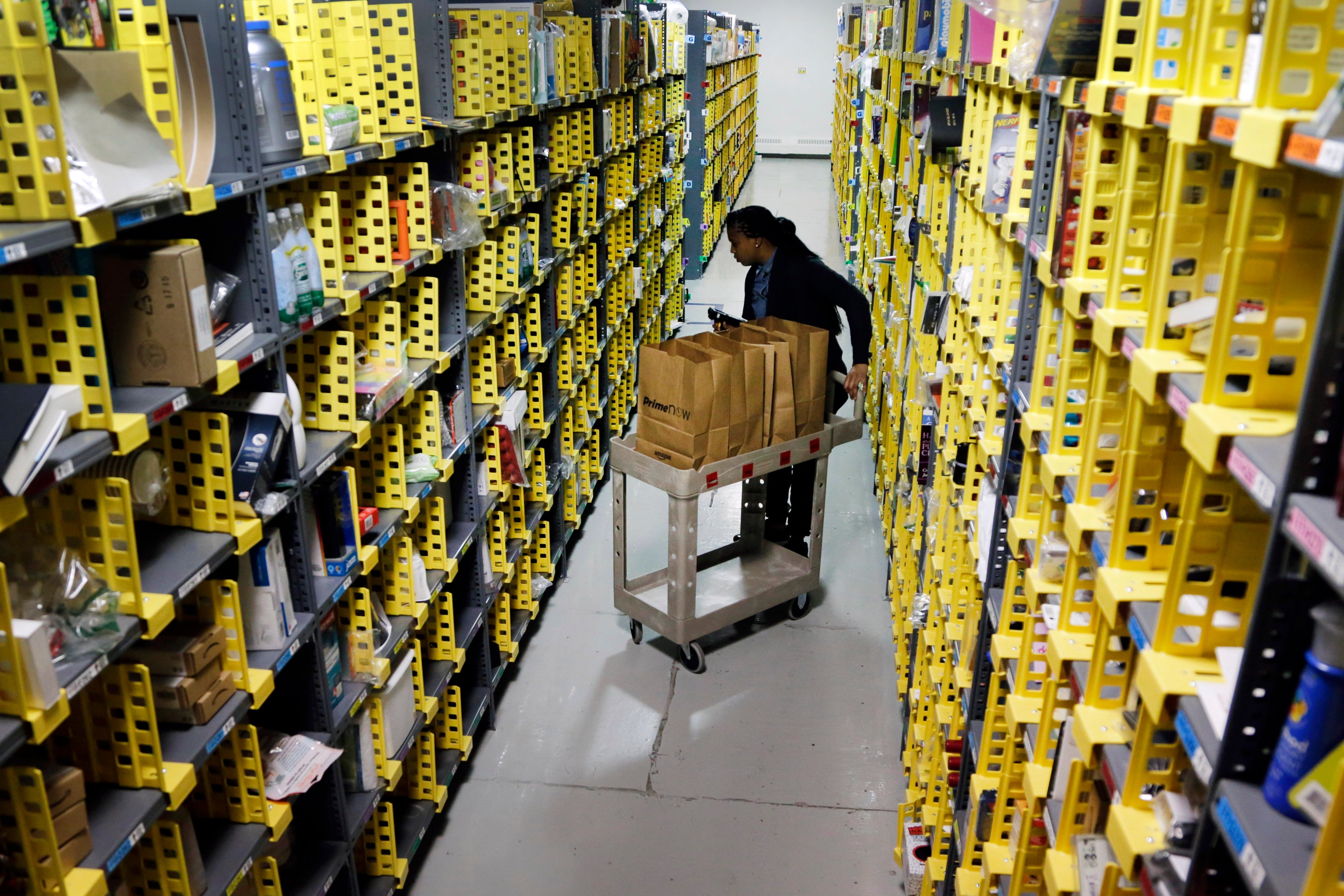 Amazon Prime employee Alicia Jackson hunts for items at the company's urban fulfillment facility that have been ordered by customers on Dec. 22, 2015, in New York. (Mark Lennihan—AP)