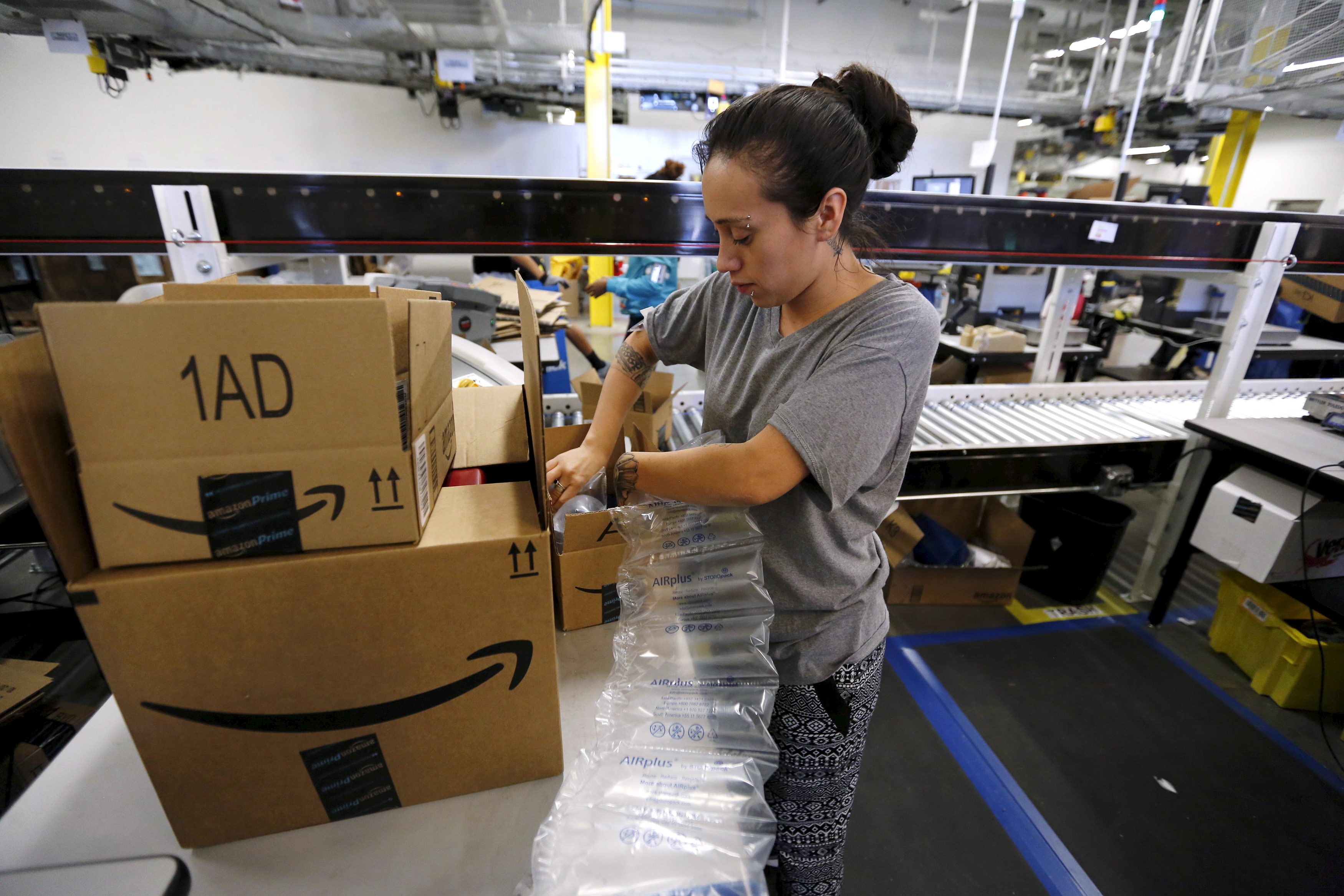 Monica Galvan secures customers'orders with bubble wrap before they are shipped at the Amazon Fulfillment Center in Tracy, Calif., Nov. 29, 2015. (Fred Greaves—Reuters)