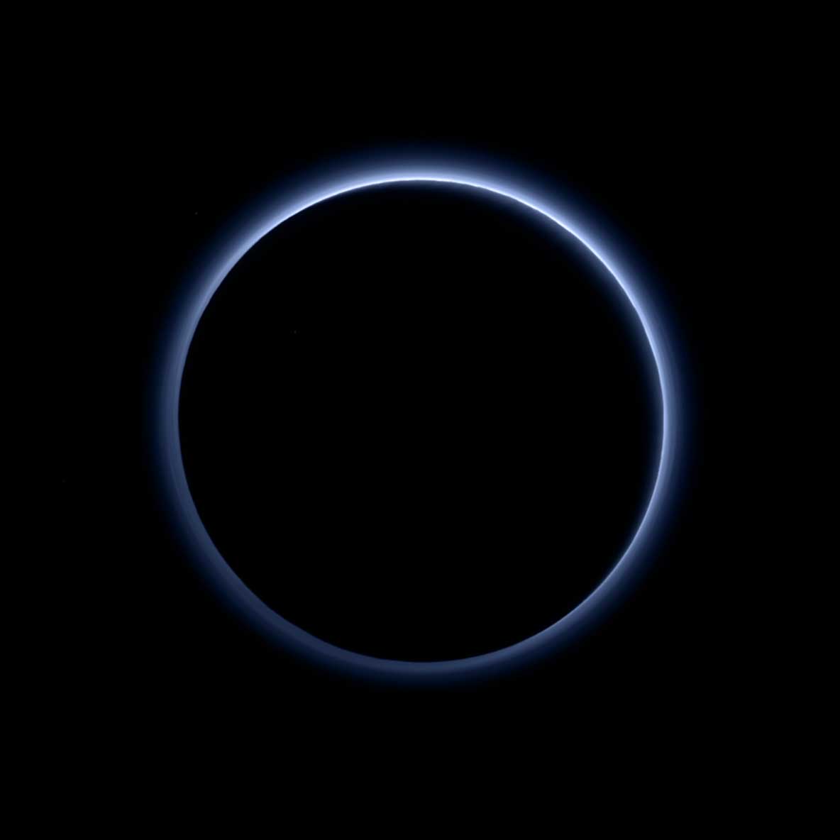 Pluto's haze layer shows its blue color in this picture taken by the New Horizons Ralph/Multispectral Visible Imaging Camera (MVIC). The high-altitude haze is thought to be similar in nature to that seen at Saturn’s moon Titan. The source of both hazes likely involves sunlight-initiated chemical reactions of nitrogen and methane, leading to relatively small, soot-like particles (called tholins) that grow as they settle toward the surface. This image was generated by software that combines information from blue, red and near-infrared images to replicate the color a human eye would perceive as closely as possible.More: New Horizons Finds Blue Skies and Water Ice on PlutoImage Credit: NASA/JHUAPL/SwRILast Updated: Oct. 8, 2015Editor: Sarah Loff