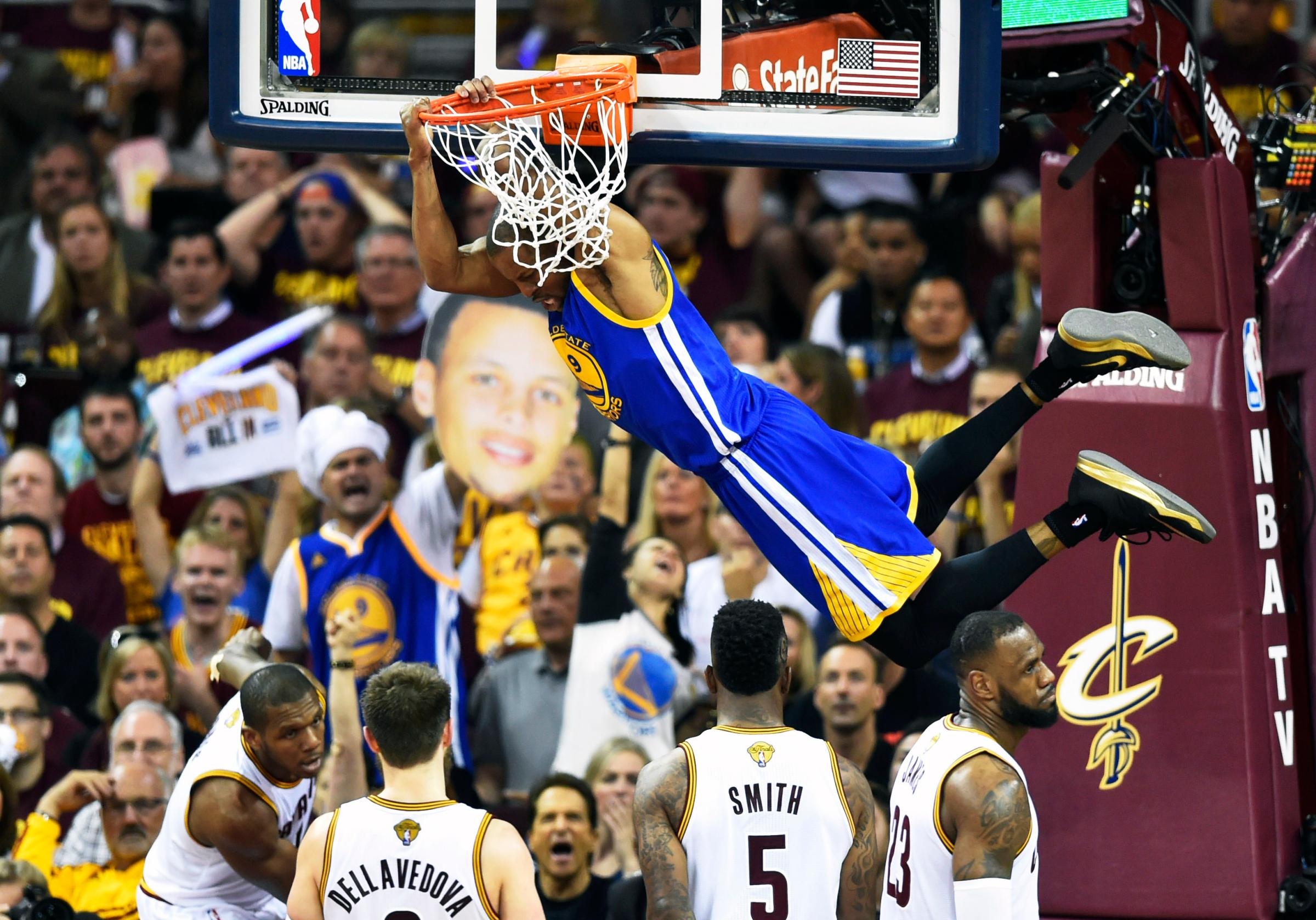 Golden State Warriors guard Andre Iguodala (9) dunks against Cleveland Cavaliers forward James Jones (1), guard Matthew Dellavedova (8), guard J.R. Smith (5), and forward LeBron James (23), bottom right, during game six of the NBA Finals in Cleveland on June 17, 2015.