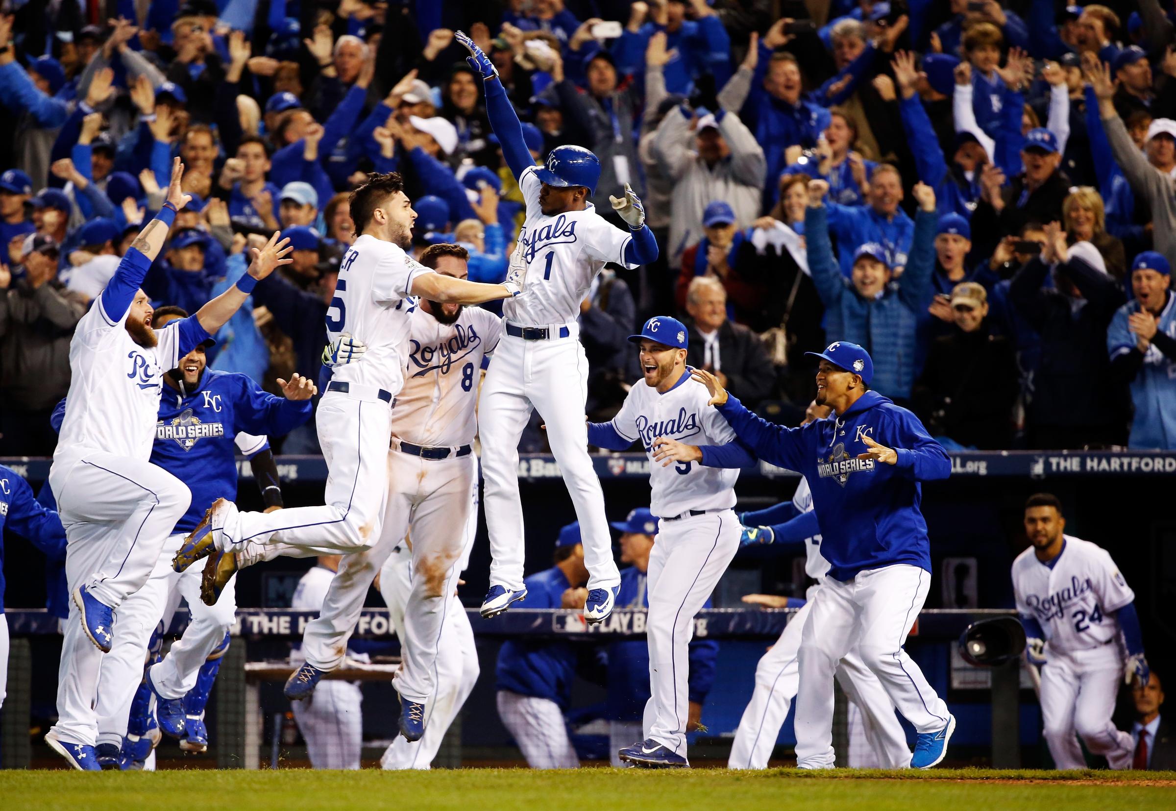 Kansas City Royals players Eric Hosmer (35), Mike Moustakas (8) and Jarrod Dyson (1) celebrate defeating the New York Mets in 14 innings during Game One of the World Series at Kauffman Stadium on Oct. 27, 2015 in Kansas City, Mo.