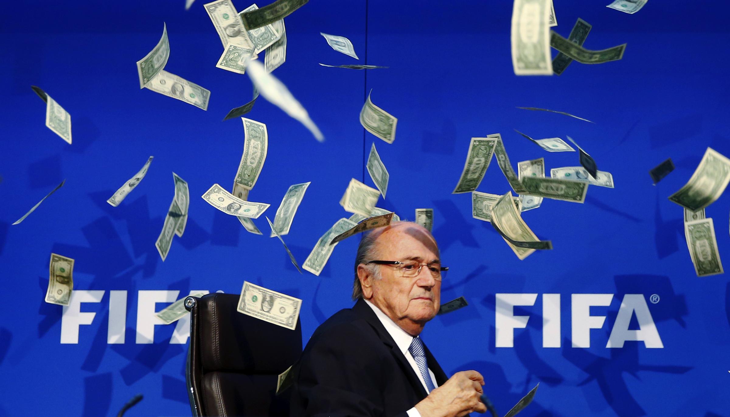 FIFA President Sepp Blatter is surrounded by banknotes thrown by a British comedian known as Lee Nelson at a news conference following the Extraordinary FIFA Executive Committee Meeting at FIFA headquarters in Zurich on July 20, 2015.