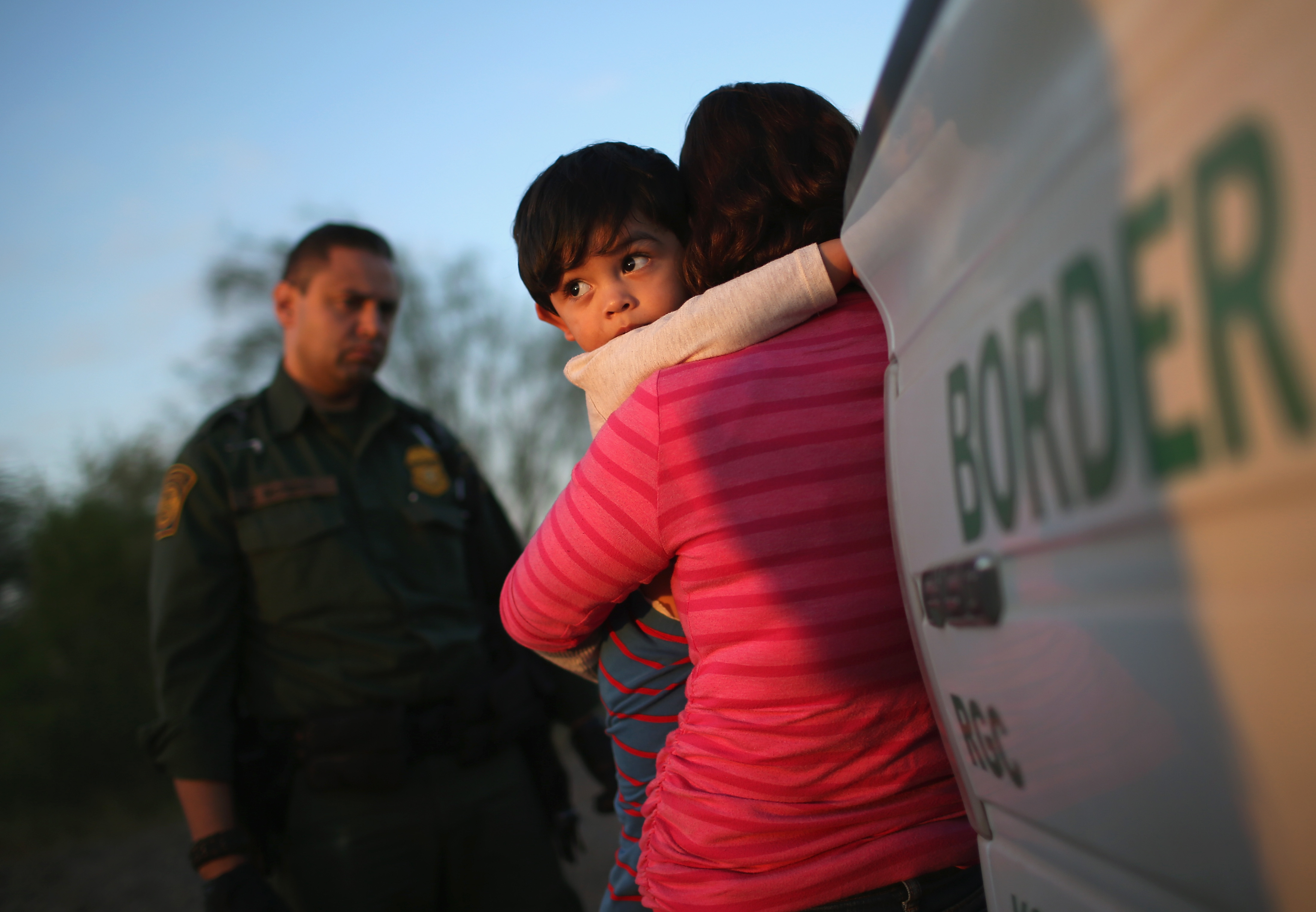 A one-year-old from El Salvador clings to his mother after she turned themselves in to Border Patrol agents on Dec. 7, 2015 near Rio Grande City, Texas. (John Moore—Getty Images)