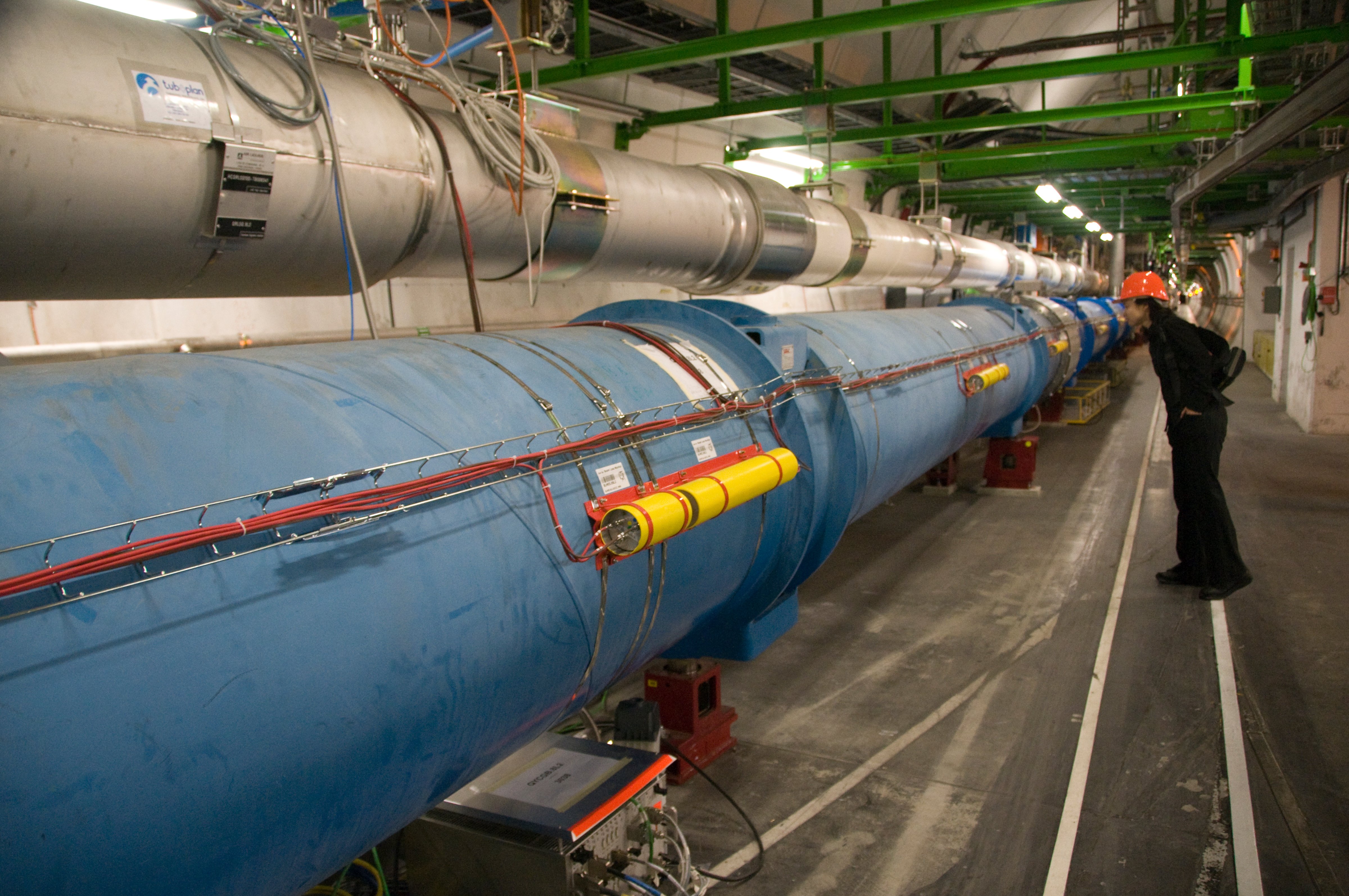 A woman looking at Large Hadron Collider, Geneva, Switzerland (Frans Lanting—Getty Images/Mint Images RM)