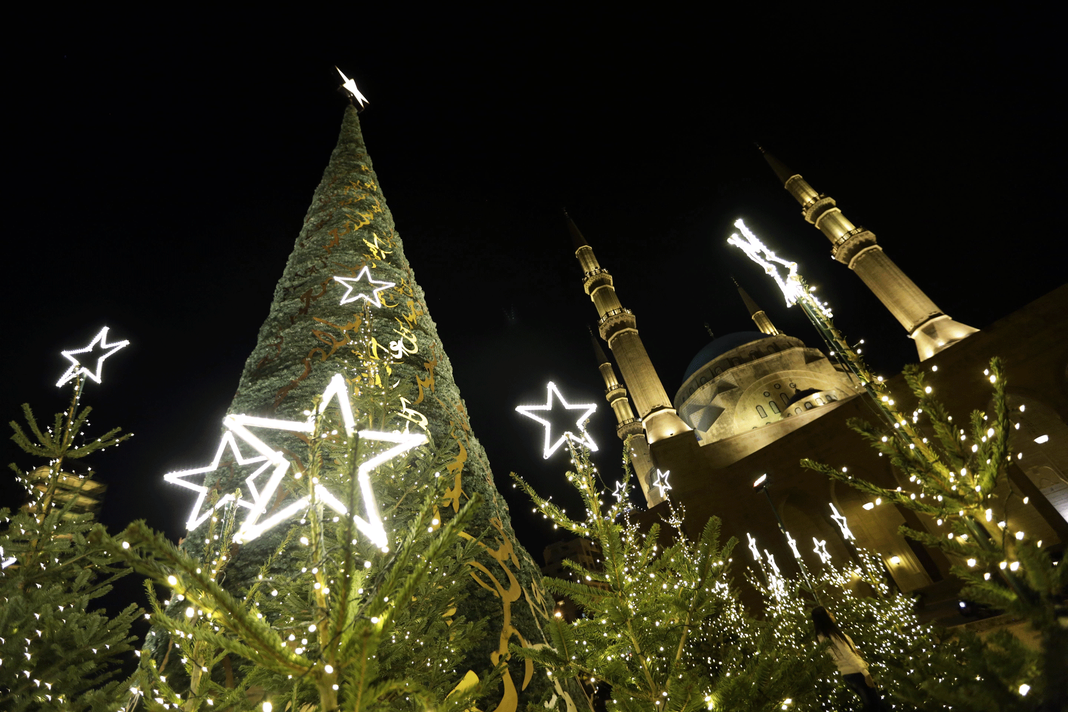 A Christmas tree is illuminated in front of the al-Amin Mosque on Martyrs' Square in Beirut on Dec. 11, 2015. (Photo by Ratib Al Safadi/Anadolu Agency/Getty Images)