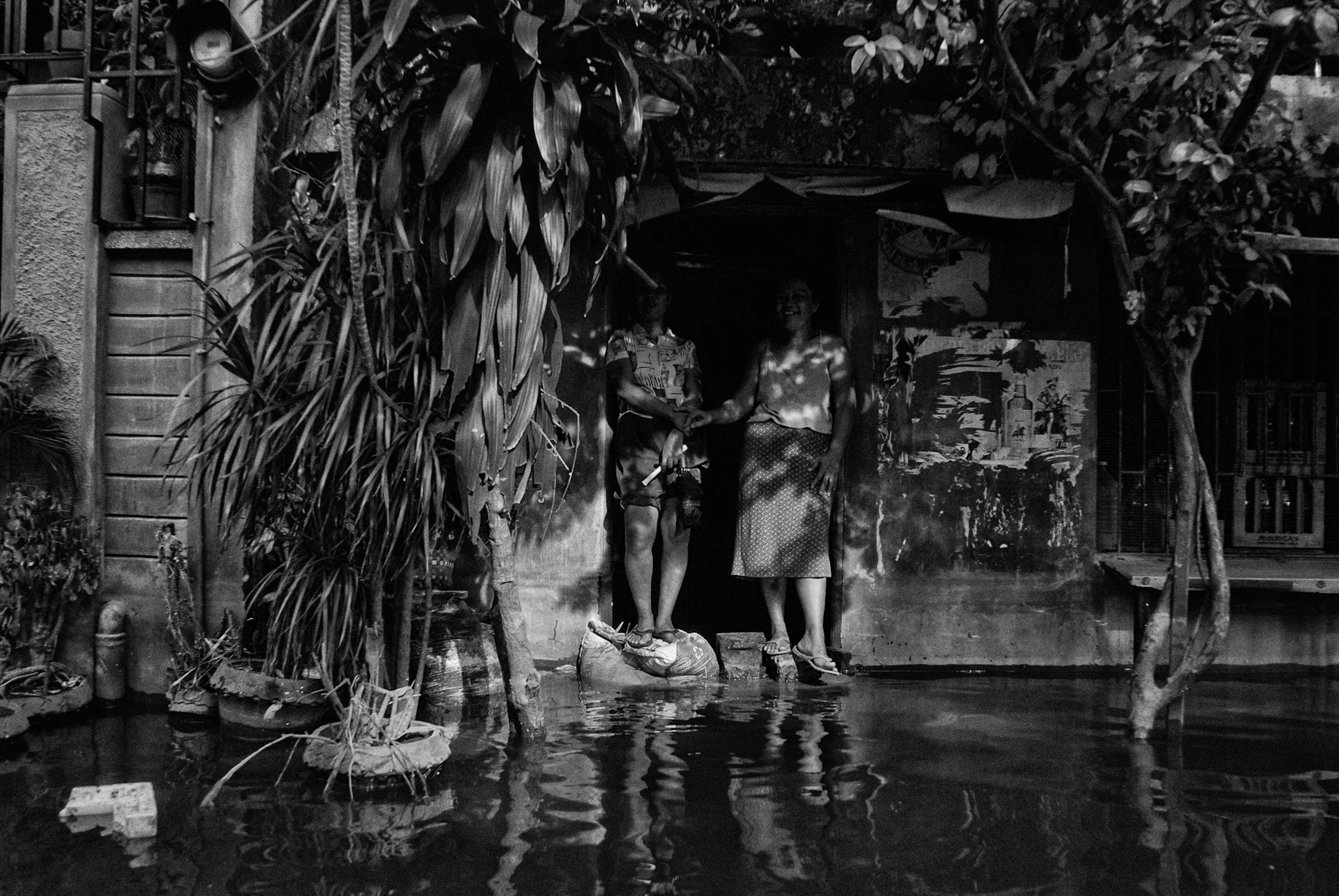 Residents wait for relief packs in Taguig city as floodwaters inundate their access to the town center on Oct. 10, 2009.