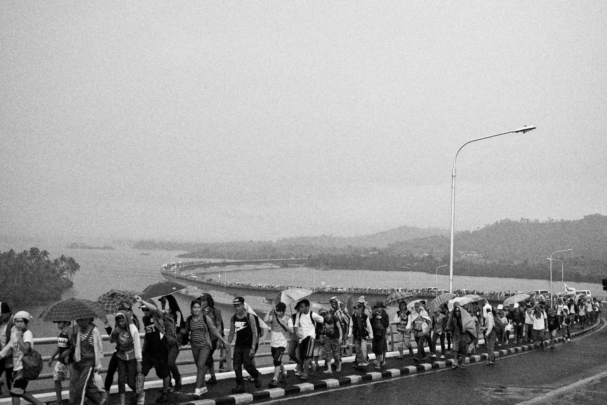 Protesters from different parts of Visayas cross the San Juanico Bridge on Nov. 7, 2014, to meet with other survivors of disasters converging to mark the first year anniversary of Typhoon Haiyan.