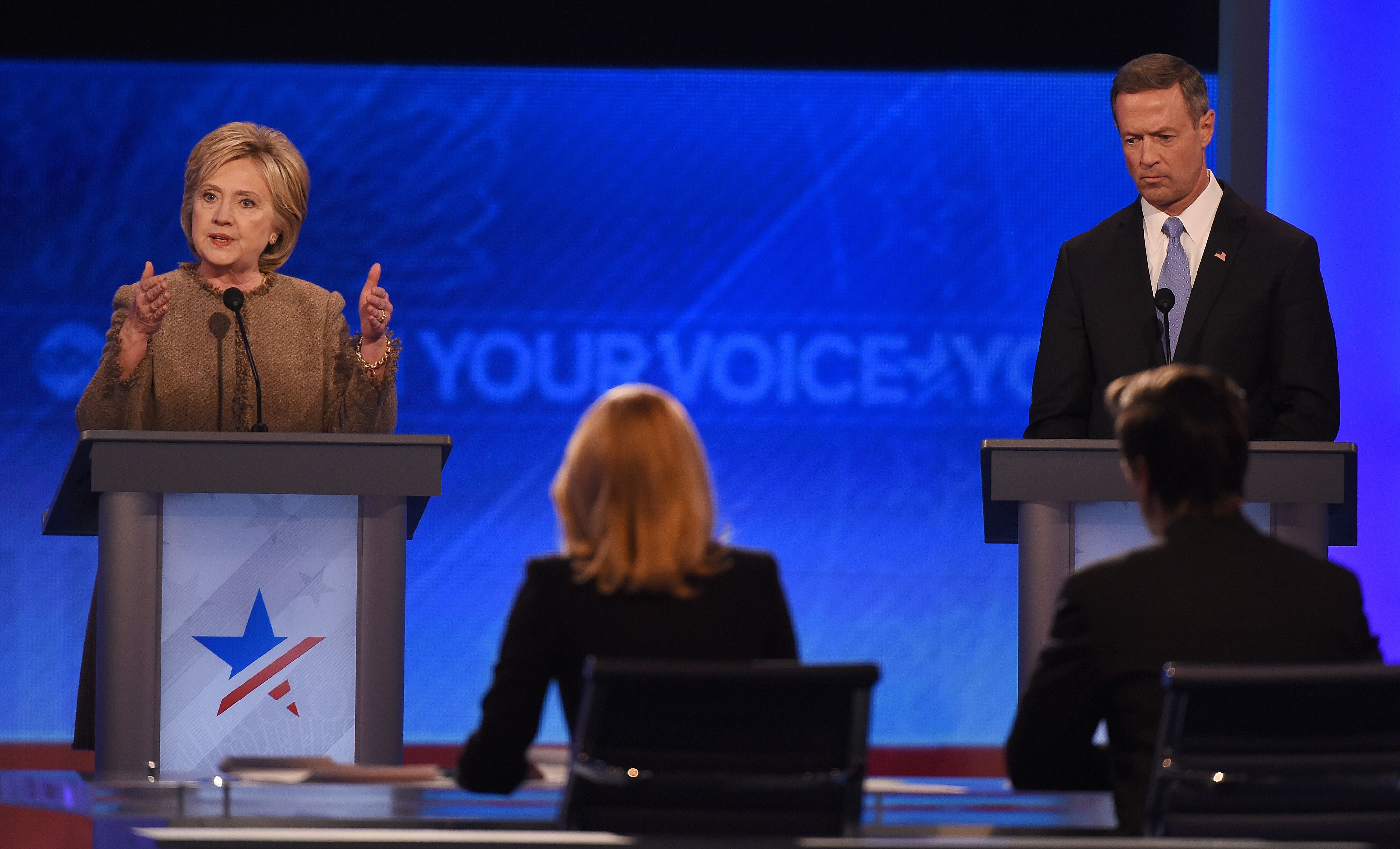 Hillary Clinton, left, speaks as fellow candidate Martin O'Malley listens during the Democratic Presidential Debate hosted by ABC News at Saint Anselm College in Manchester, New Hampshire, on Dec. 19, 2015. (Jewel Samad—AFP/Getty Images)