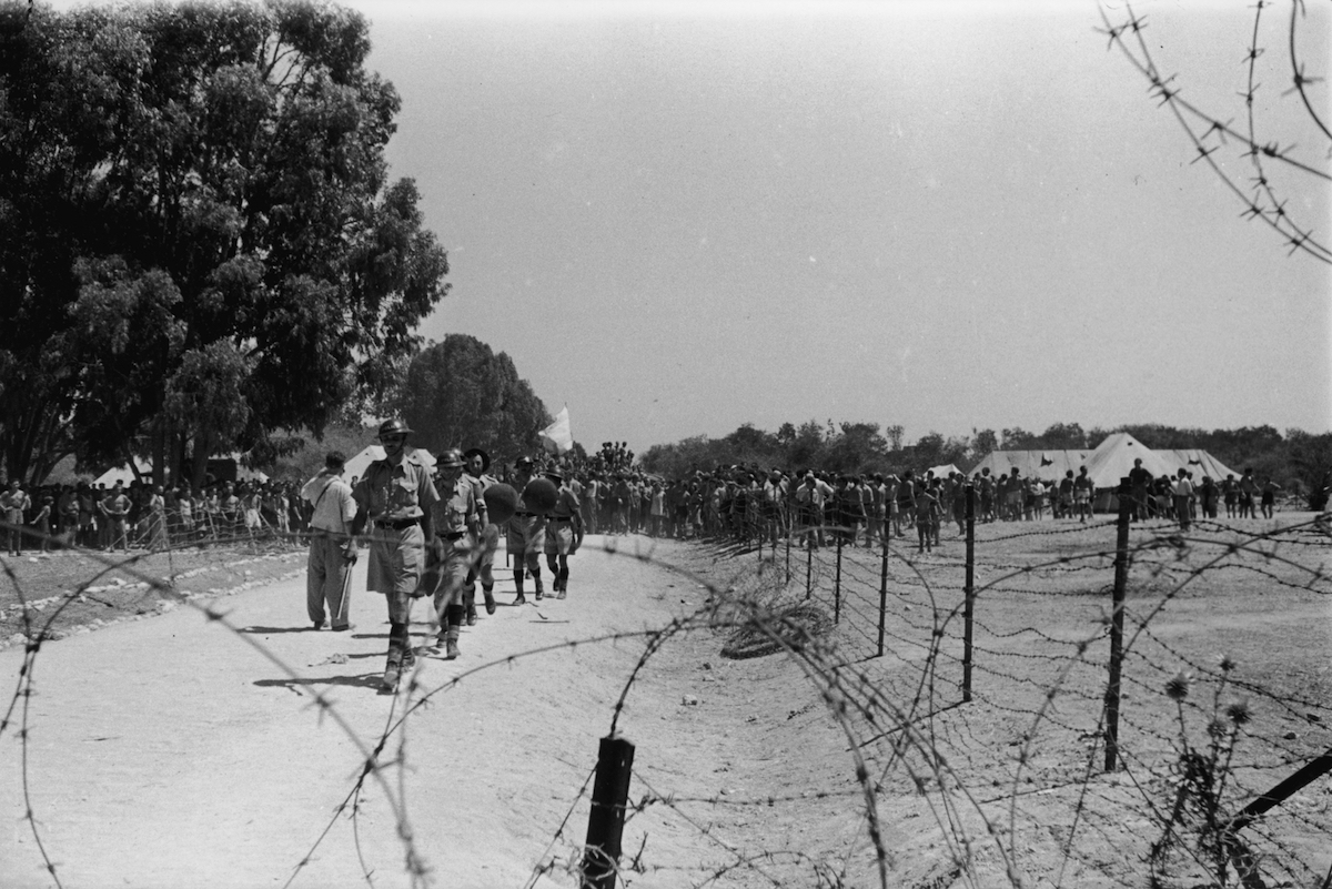 September 1946:  British troops and Jewish immigrants at the camp near Famagusta, Cyprus, where Jewish refugees are being kept, having been turned away from Palestine. (Charles Hewitt&mdash;Getty Images)
