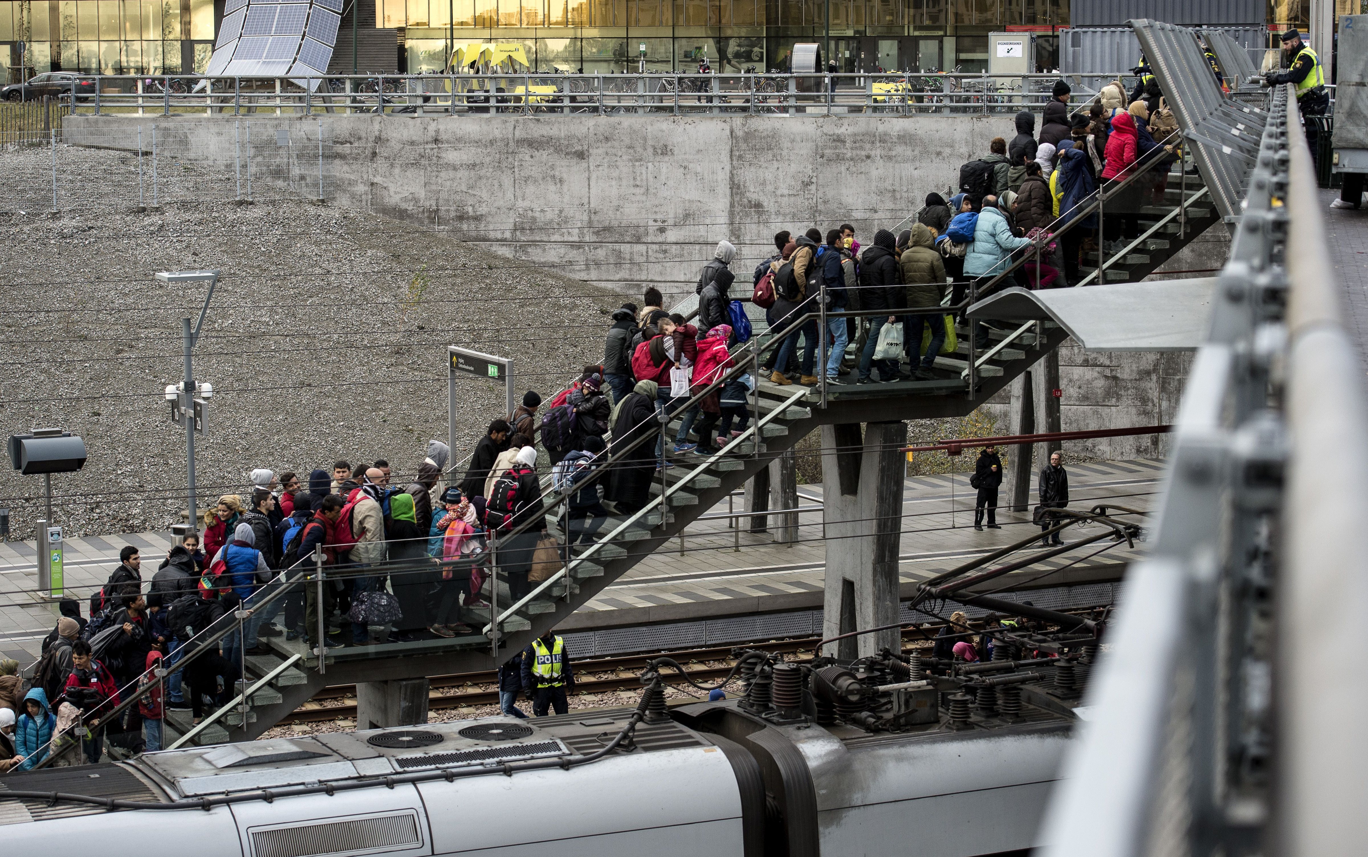 Police organize the line of refugees on the stairway leading up from the trains arriving from Denmark on Nov. 19, 2015 (Johan Nilsson—AFP/Getty Images)