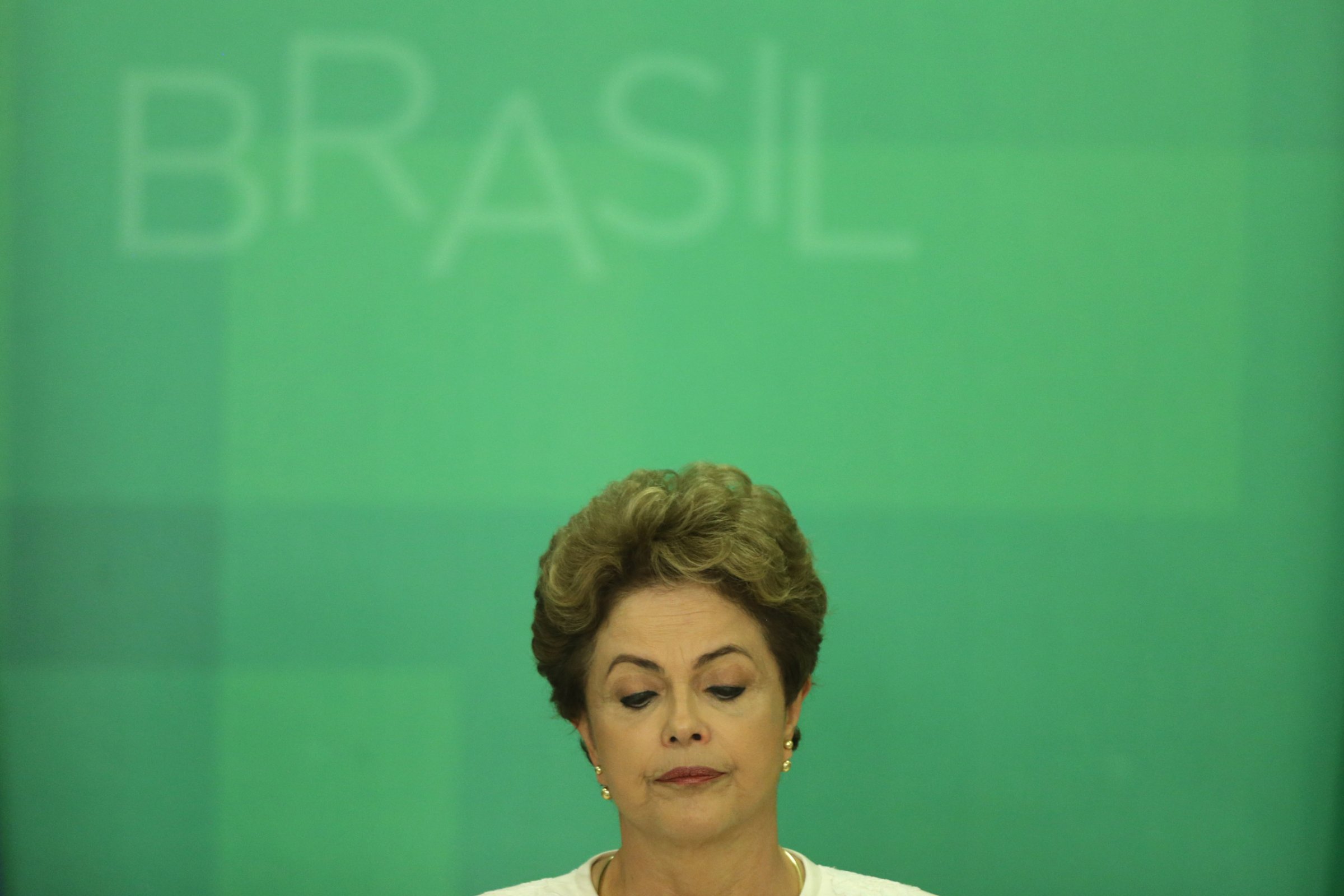 Brazil's President Dilma Rousseff looks down during a press conference after impeachment proceedings were opened against her by the President of Chamber of Deputies Eduardo Cunha, at the Planalto Presidential Palace in Brasilia, Brazil, Wednesday, Dec. 2, 2015. The speaker of the nation's lower house says he's opening the impeachment process based on accusations that Rousseff's government broke fiscal responsibility laws this year. (AP Photo/Eraldo Peres)
