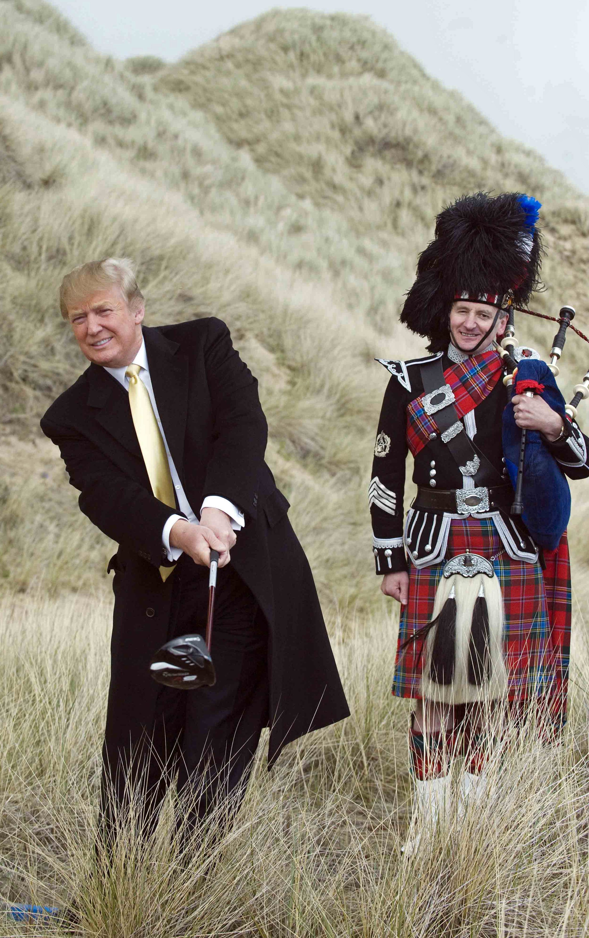 Donald Trump (L) poses for photographers during a visit to the construction site of his golf course on the Menie Estate near Aberdeen, Scotland on May 27, 2010.