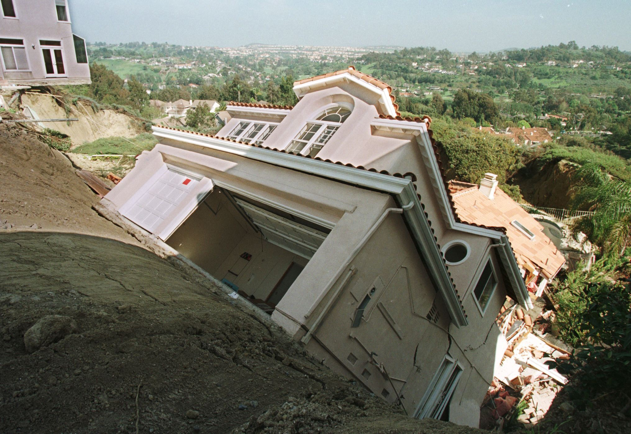 A California home slides down a hill after erosion due to rains tied to El Nino in March, 1998. (Vince Bucci—AFP/Getty Images)