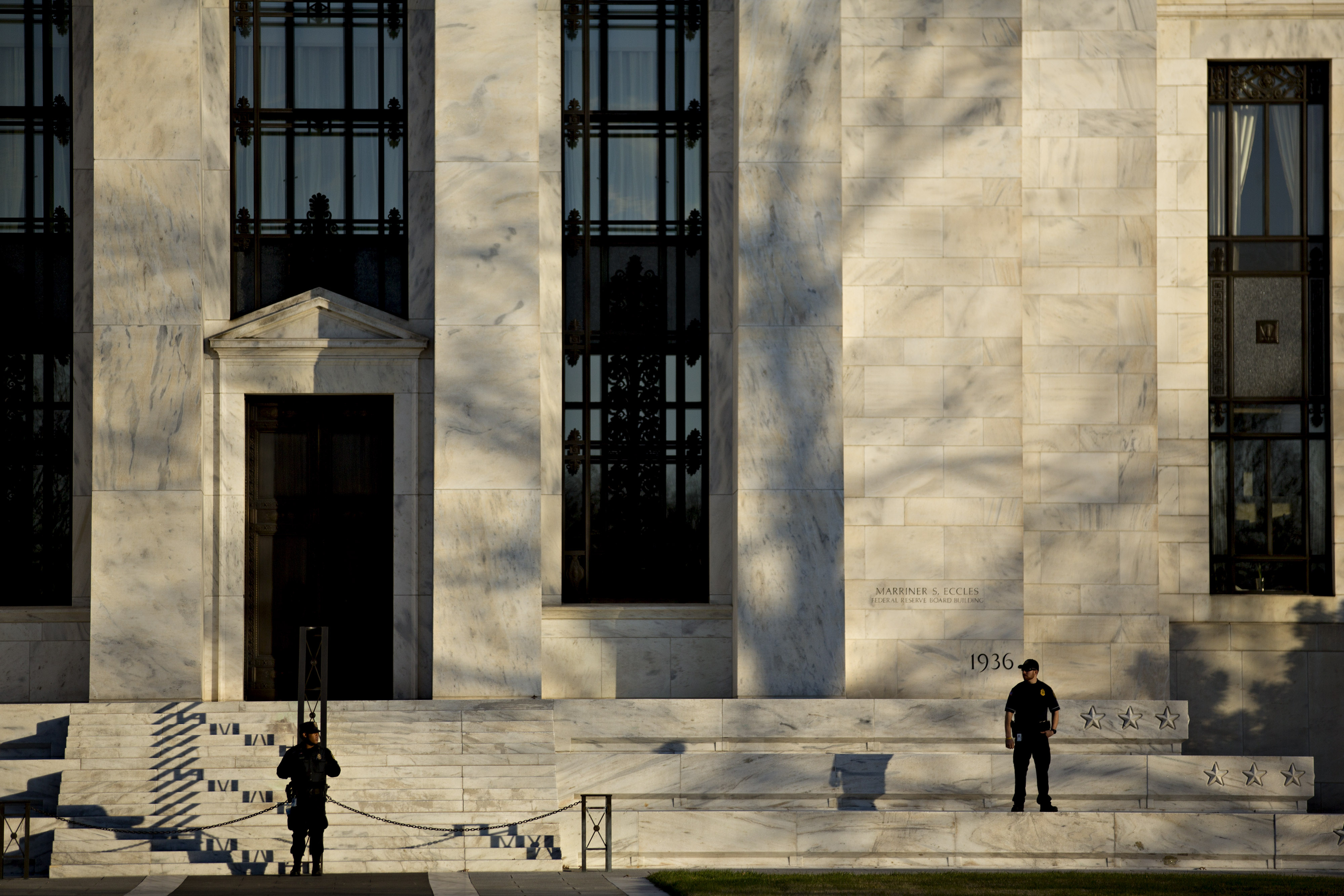Federal Reserve police officers stand in front of the Marriner S. Eccles Federal Reserve building in Washington, D.C., on Dec. 15, 2015. (Andrew Harrer—Bloomberg/Getty Images)
