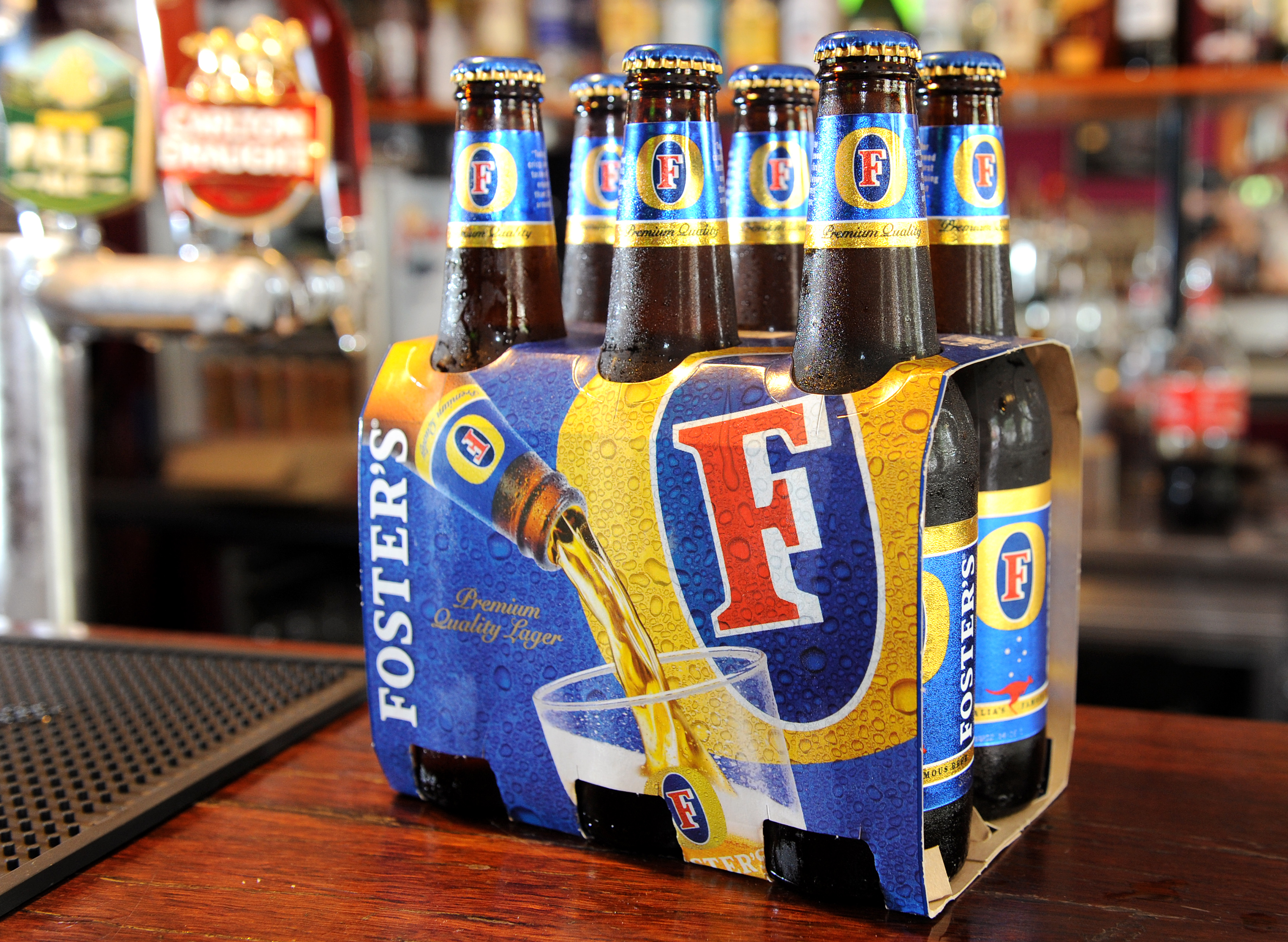 Bottles of Foster's beer sits on the bar at the Drop Bear Inn in South Melbourne on November 25, 2011. (William West&mdash;AFP/Getty Images)