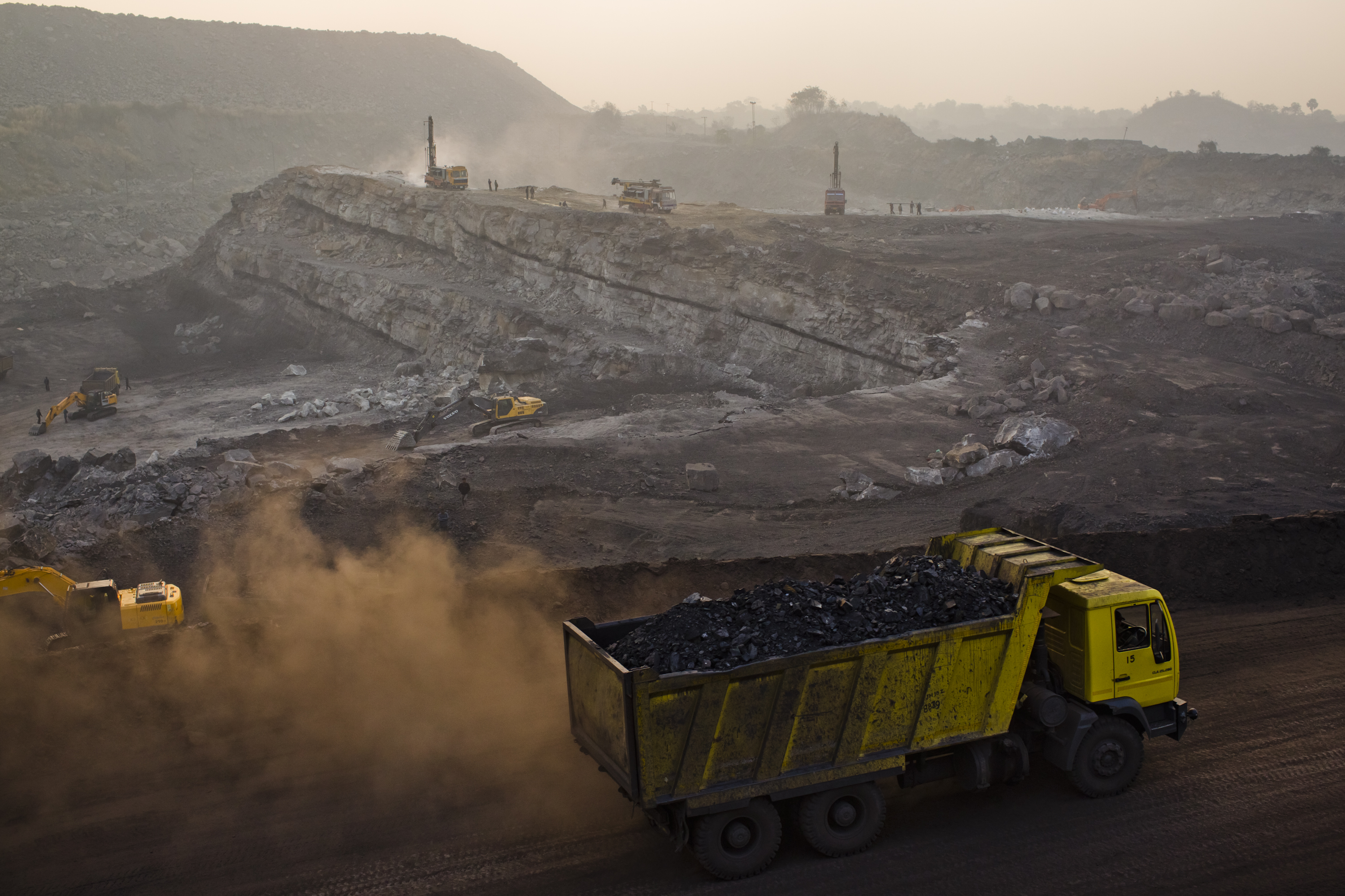 A fully laden truck carrying coal drives out of an open-cast coal mine as excavation work continues in the Indian village of Jina Gora, near Jharia, on Feb. 9, 2012 (Daniel Berehulak—Getty Images)