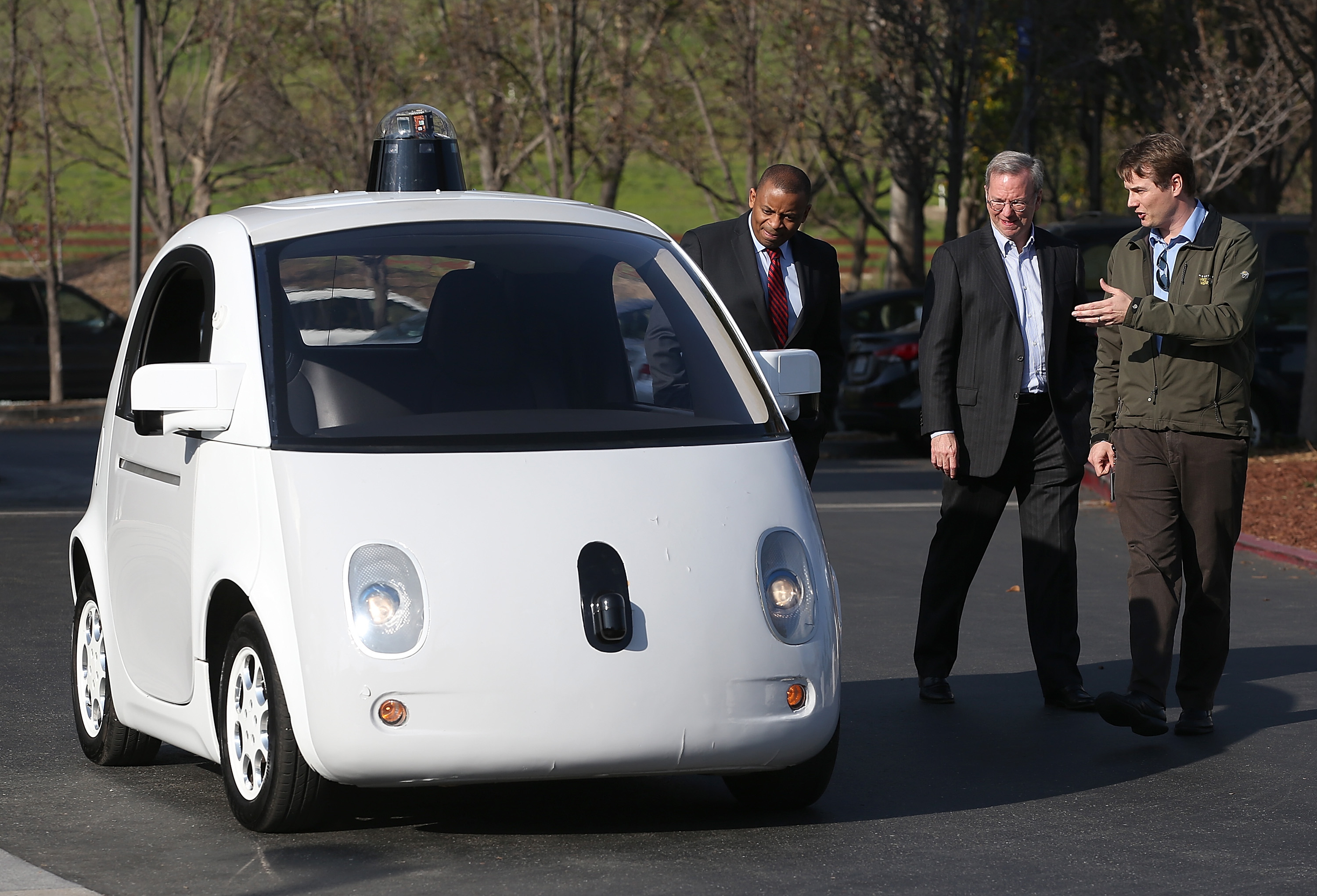 Google's Chris Urmson (R) shows a Google self-driving car to U.S. Transportation Secretary Anthony Foxx (L) and Google Chairman Eric Schmidt (C) at the Google headquarters on February 2, 2015 in Mountain View, California.  U.S. Transportation Secretary Anthony Foxx joined Google Chairman Eric Schmidt for a fireside chat where he unveiled Beyond Traffic, a new analysis from the U.S. Department of Transportation that anticipates the trends and choices facing our transportation system over the next three decades. (Justin Sullivan—Getty Images)