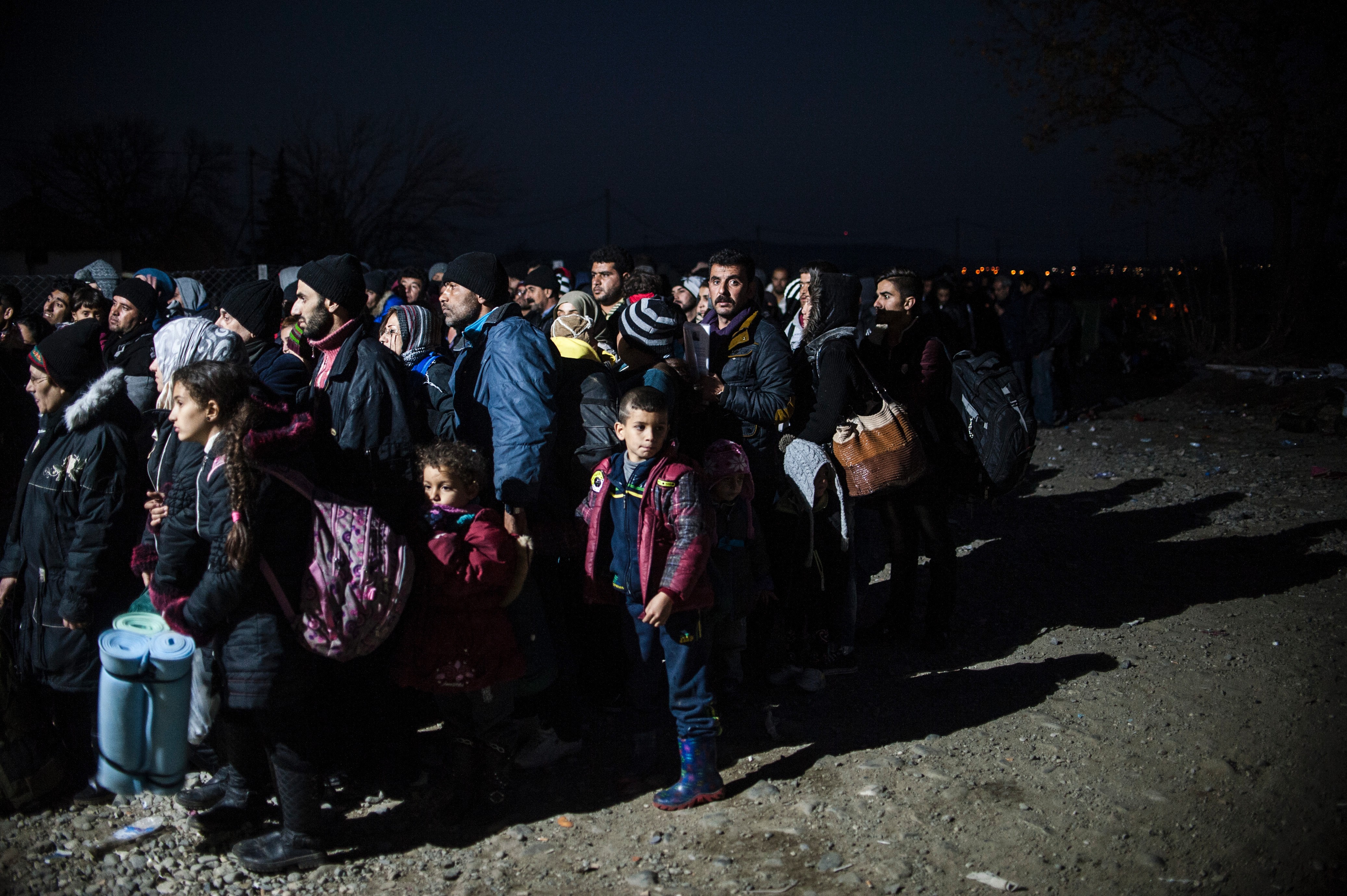 Migrants wait to enter a refugee camp after crossing the Greek-Macedonian border, near Gevgelija, Macedonia, on Dec. 5, 2015 (Armend Nimani—AFP/Getty Images)