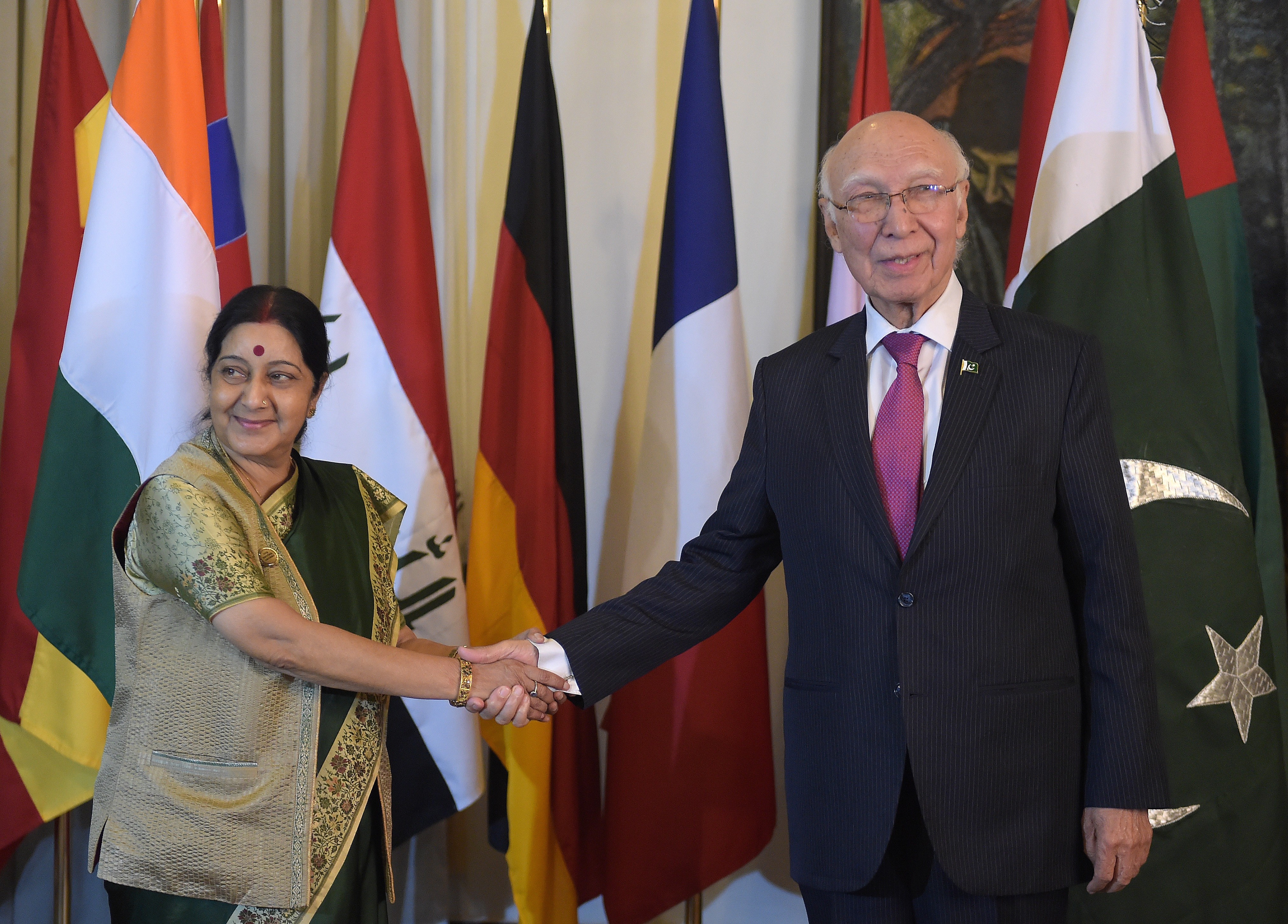 Pakistan's prime-ministerial adviser on foreign affairs Sartaj Aziz, right, shakes hands with Indian Foreign Minister Sushma Swaraj in Islamabad on Dec. 9, 2015 (Aamir Qureshi—AFP/Getty Images)