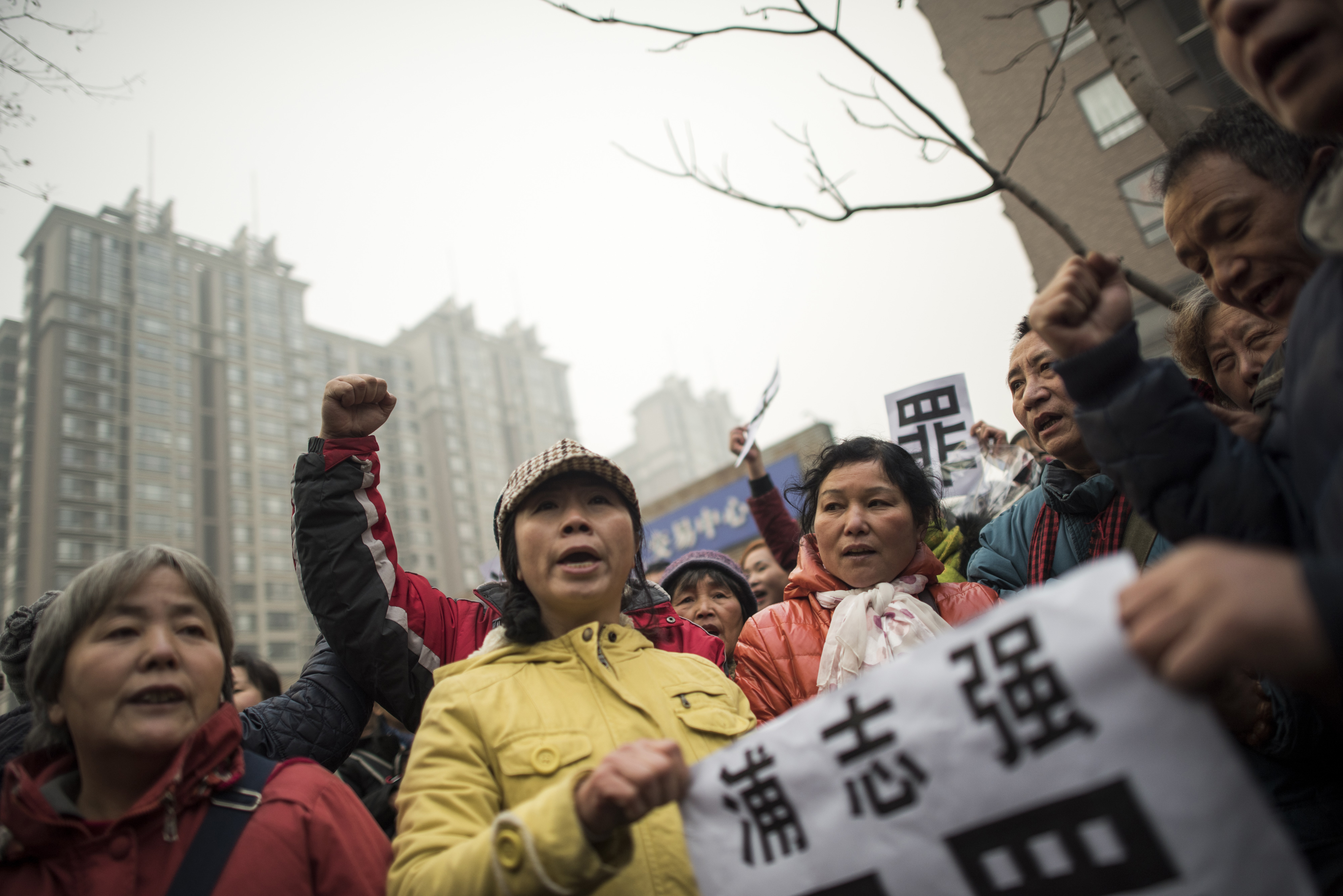 Supporters of human-rights lawyer Pu Zhiqiang hold a placard that reads "Pu Zhiqiang, Innocent" during a demonstration near the Beijing No. 2 Intermediate People's Court in Beijing on Dec. 14, 2015 (Fred Dufour—AFP/Getty Images)