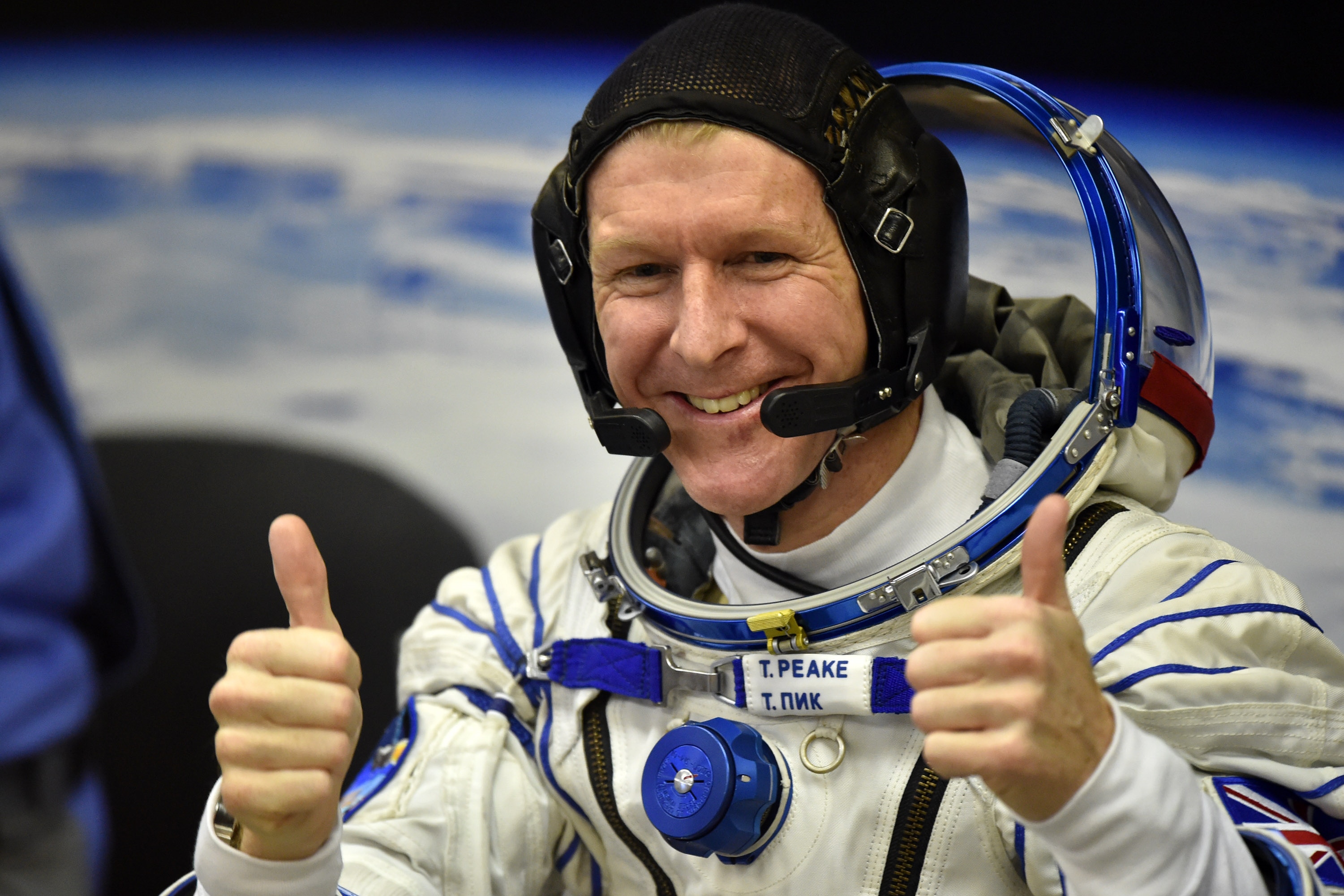 Britain's astronaut Tim Peake gestures as his space suit is tested at the Russian-leased Baikonur cosmodrome, prior to blasting off to the International Space Station (ISS), on Dec. 15, 2015. (Kirill Kudryavtsev—AFP/Getty Images)