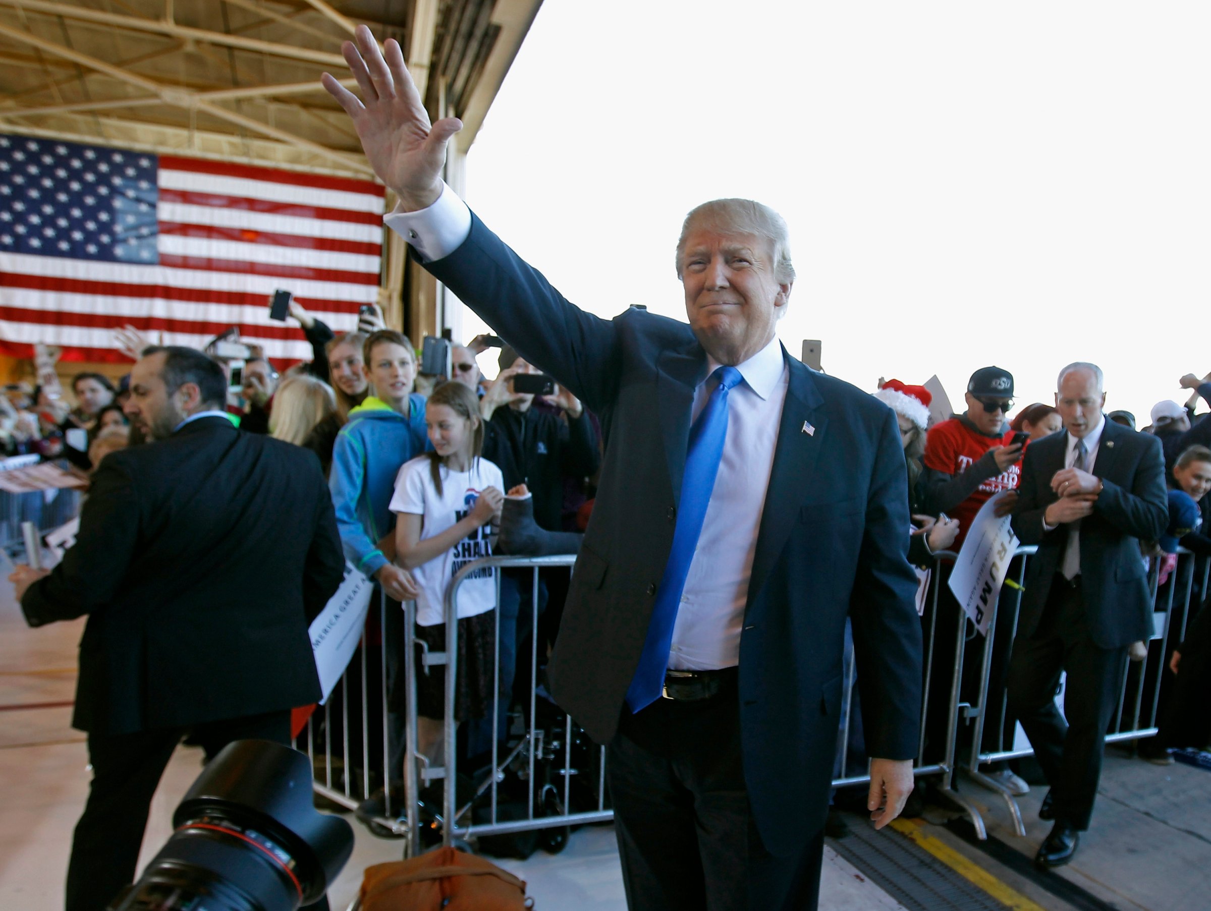 Donald Trump waves to the crowd as he arrives at a campaign event at the International Air Response facility on Dec. 16 in Mesa, Arizona.