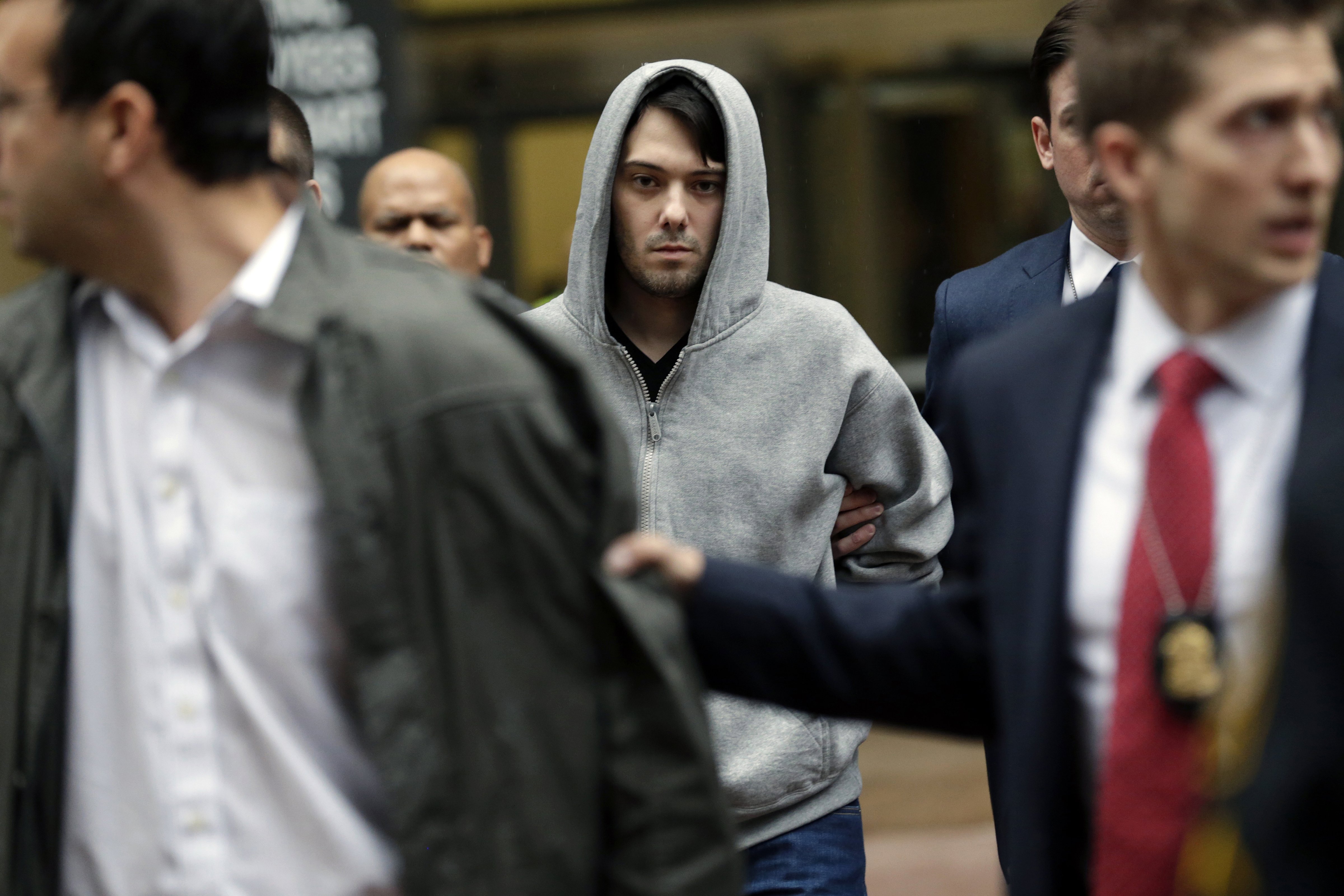 Martin Shkreli, chief executive officer of Turing Pharmaceuticals, center, exits federal court in New York City on Dec. 17, 2015 (Peter Foley—Bloomberg/Getty Images)