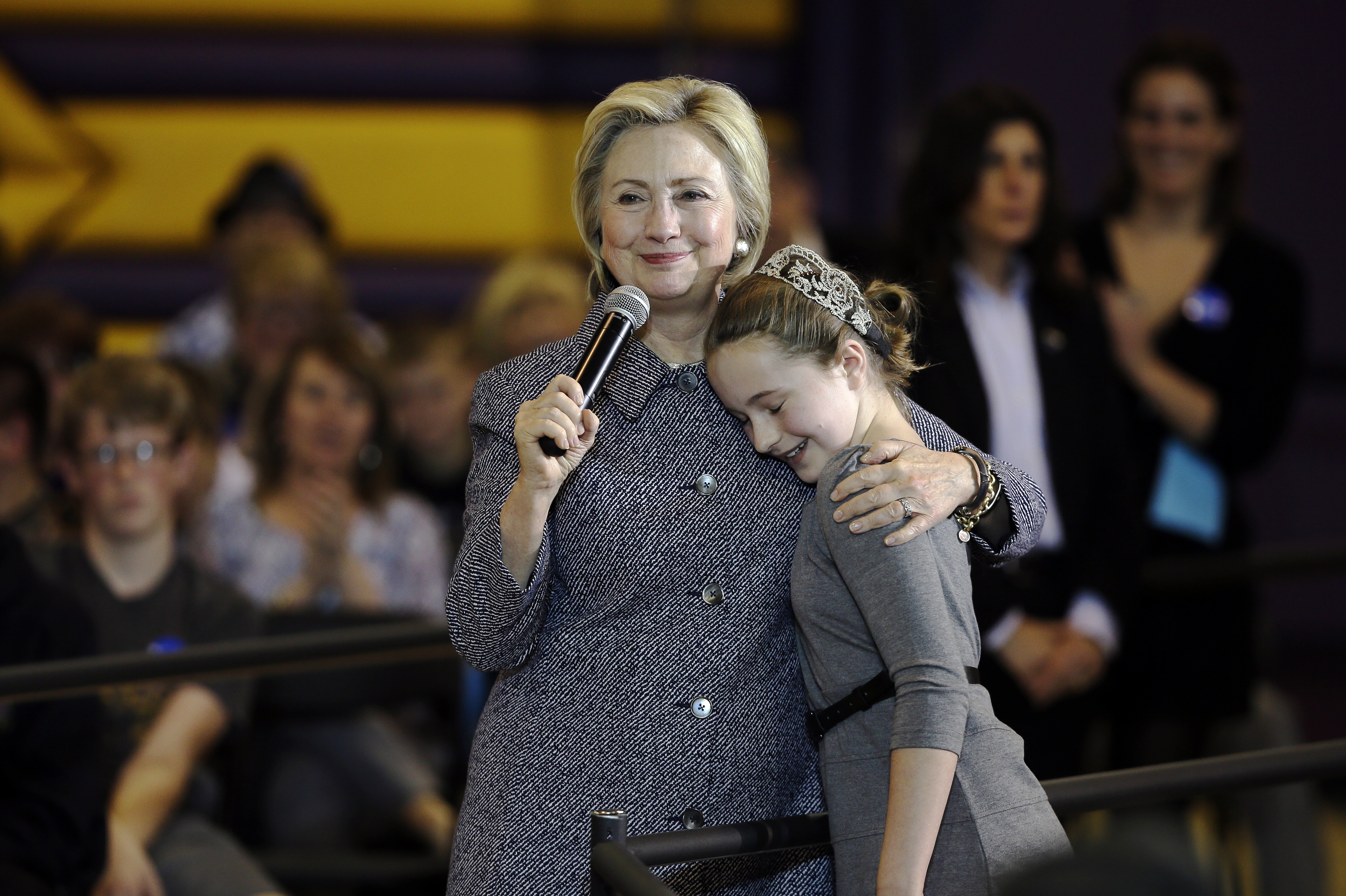 Democratic presidential candidate Hillary Clinton hugs fifth-grader Hannah Tandy during a town hall meeting at Keota High School on Dec. 22, 2015, in Keota, Iowa. (Charlie Neibergall—AP)
