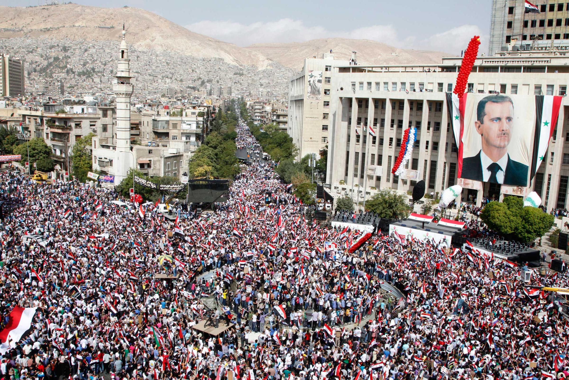 Supporters of Syrian President Bashar al-Assad's gather during a rally at al-Sabaa Bahrat square in Damascus on Oct. 12, 2011.