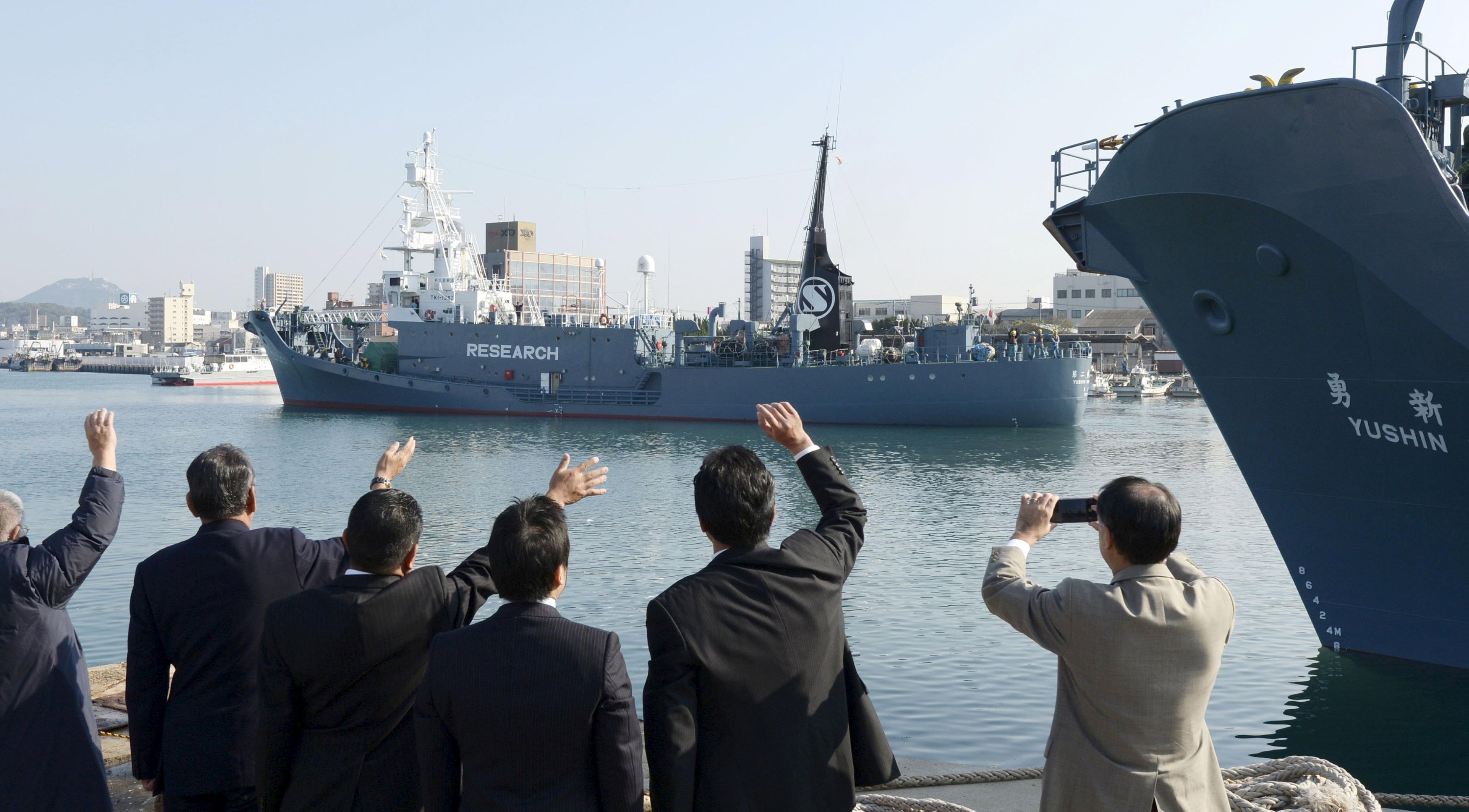 Officials wave as Japanese whaling vessel Yushin Maru No.2 leaves for the Antartic Ocean at a port in Shimonoseki, southwestern Japan on Dec. 1, 2015. (Kyodo/Reuters)