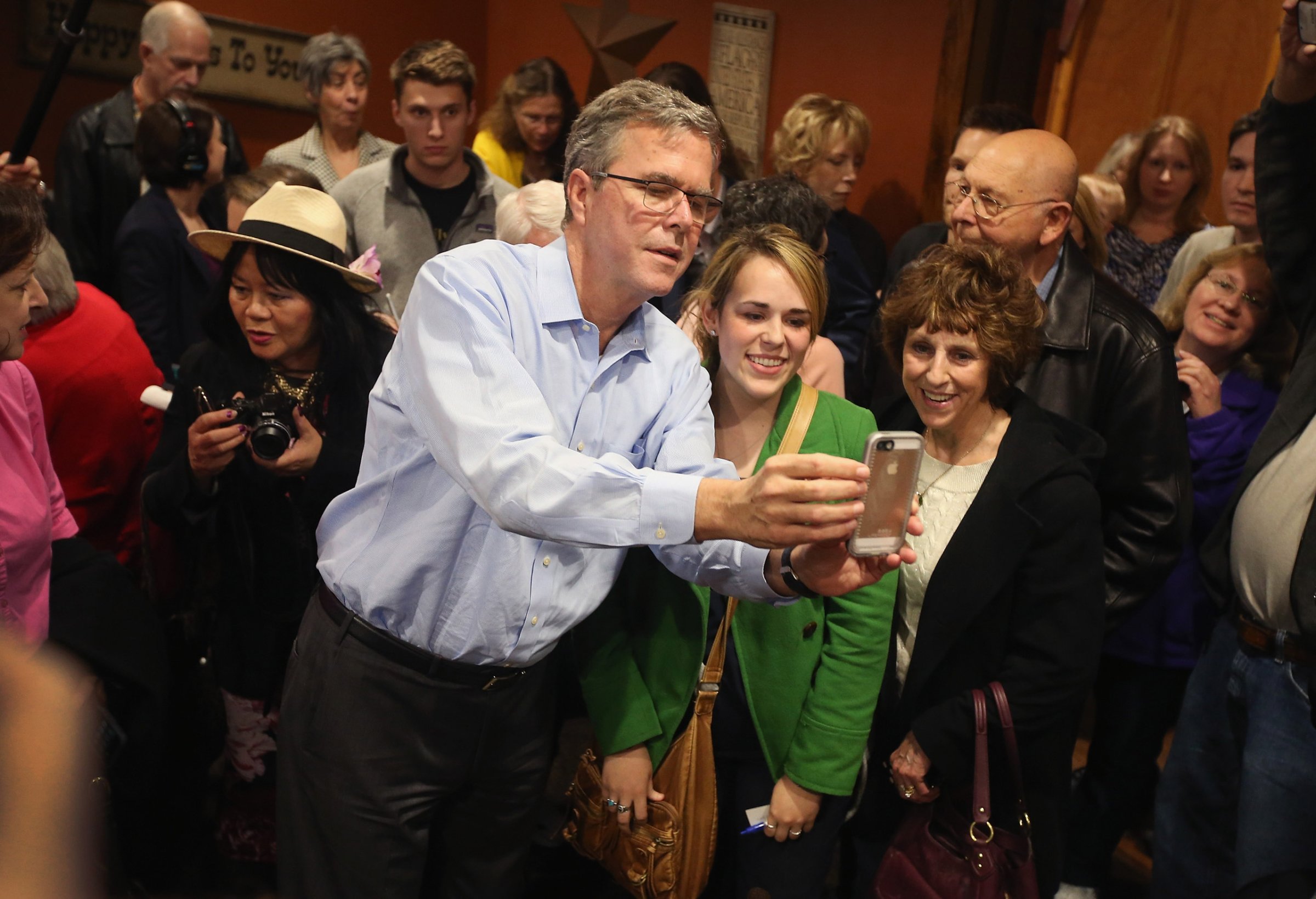 CEDAR RAPIDS, IA - MARCH 07: Former Florida Governor Jeb Bush takes a selfie with Iowa residents after speaking at a Pizza Ranch restaurant on March 7, 2015 in Cedar Rapids, Iowa. Earlier in the day Bush spoke at the Iowa Ag summit in Des Moines. The Ag Summit allowed the invited speakers, many of whom are potential 2016 Republican presidential hopefuls, to outline their views on agricultural issues. (Photo by Scott Olson/Getty Images)