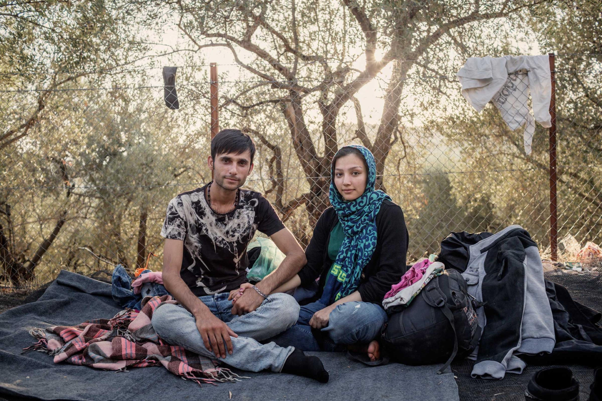 An Afghan couple, 22-year-old Noor Jan and his wife, 19-year-old Parisa, who is seven months pregnant, at the Moria registration center on the Greek island of Lesbos, where migrants and refugees wait for their papers for several days. Oct. 20, 2015.