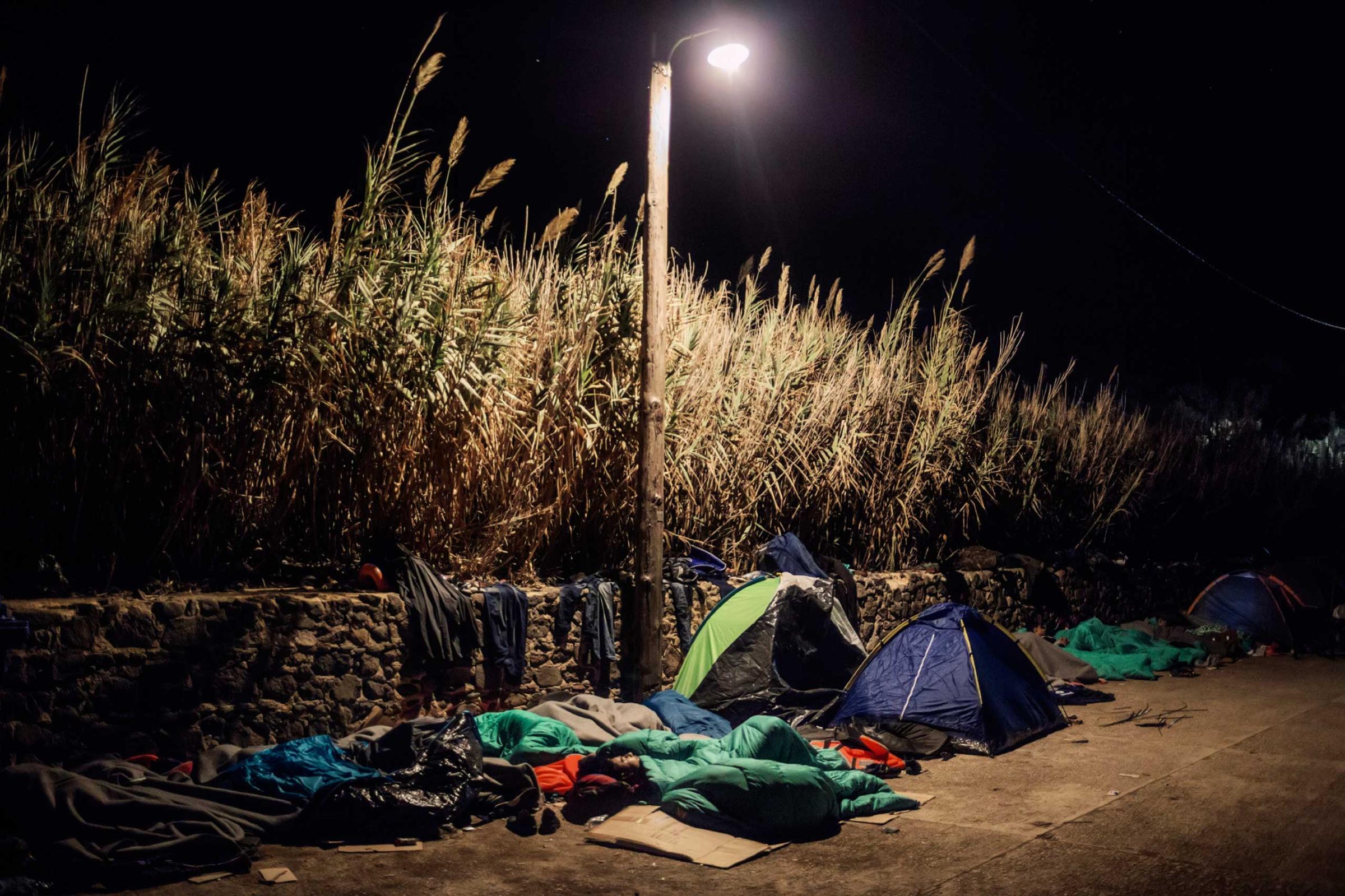 A group of Syrian migrants spend the night on the north of the Greek island of Lesbos, near the beach of Eftalou, where they landed just a few hours earlier, Oct. 16, 2015.