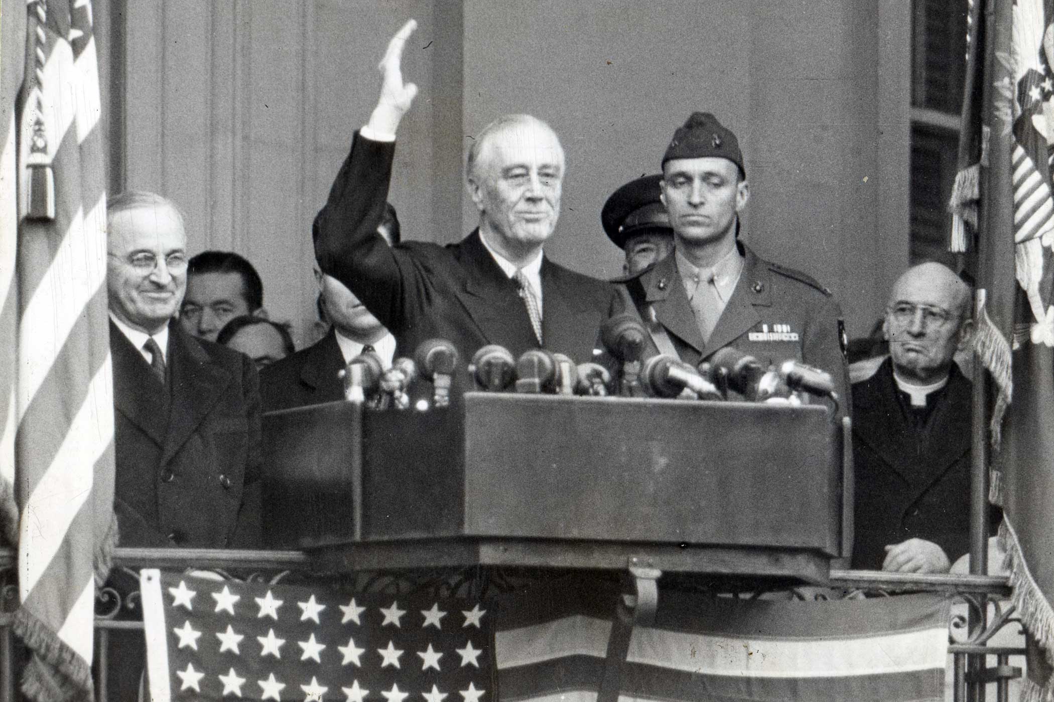 President Franklin Delano Roosevelt waves from a lectern just after he took his fourth Oath of Office in Washington in 1945. With him are his Vice President Harry S. Truman and his son James Roosevelt. Roosevelt, the longest serving president in American history, was the only president to serve more than two terms.