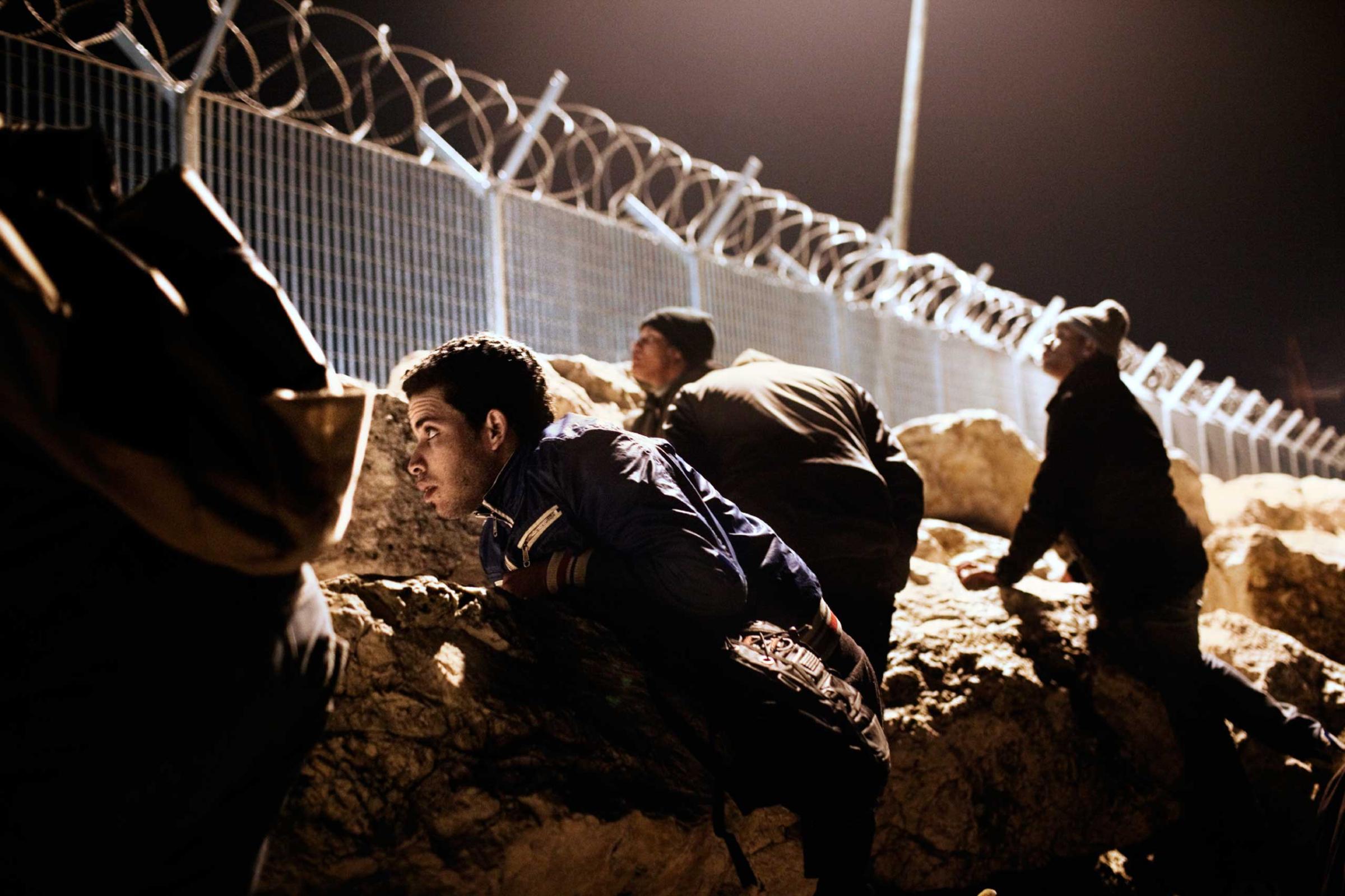 Mohamed from Morocco and his friends hid behind rocks at the port in Corinth, Greece, waiting for the right moment to illegally board a ship to Italy from Greece, 2012. Many young migrants see other European countries as their only hope of a future, and attempt to leave Greece at the first possible moment.