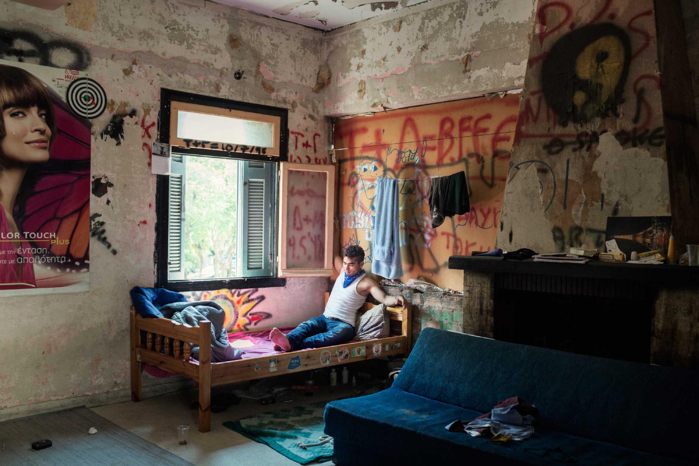 Portrait of a young Afghan in an abandoned house in Patras, Greece, 2014.