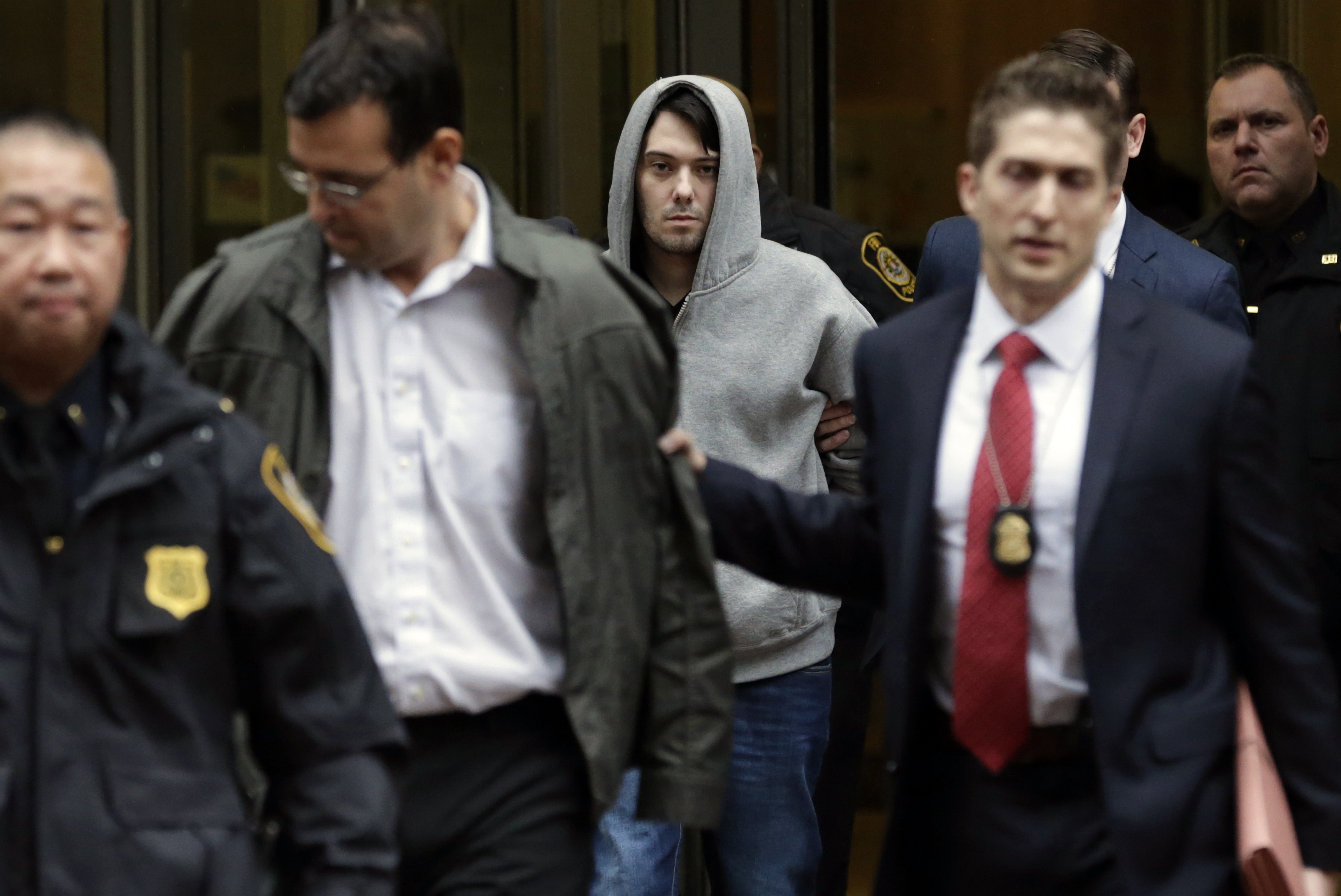 Martin Shkreli, chief executive officer of Turing Pharmaceuticals LLC, center, and attorney Evan Greebel, left, exit federal court in New York, U.S., on Thursday, Dec. 17, 2015. (Peter Foley—Bloomberg via Getty Images)