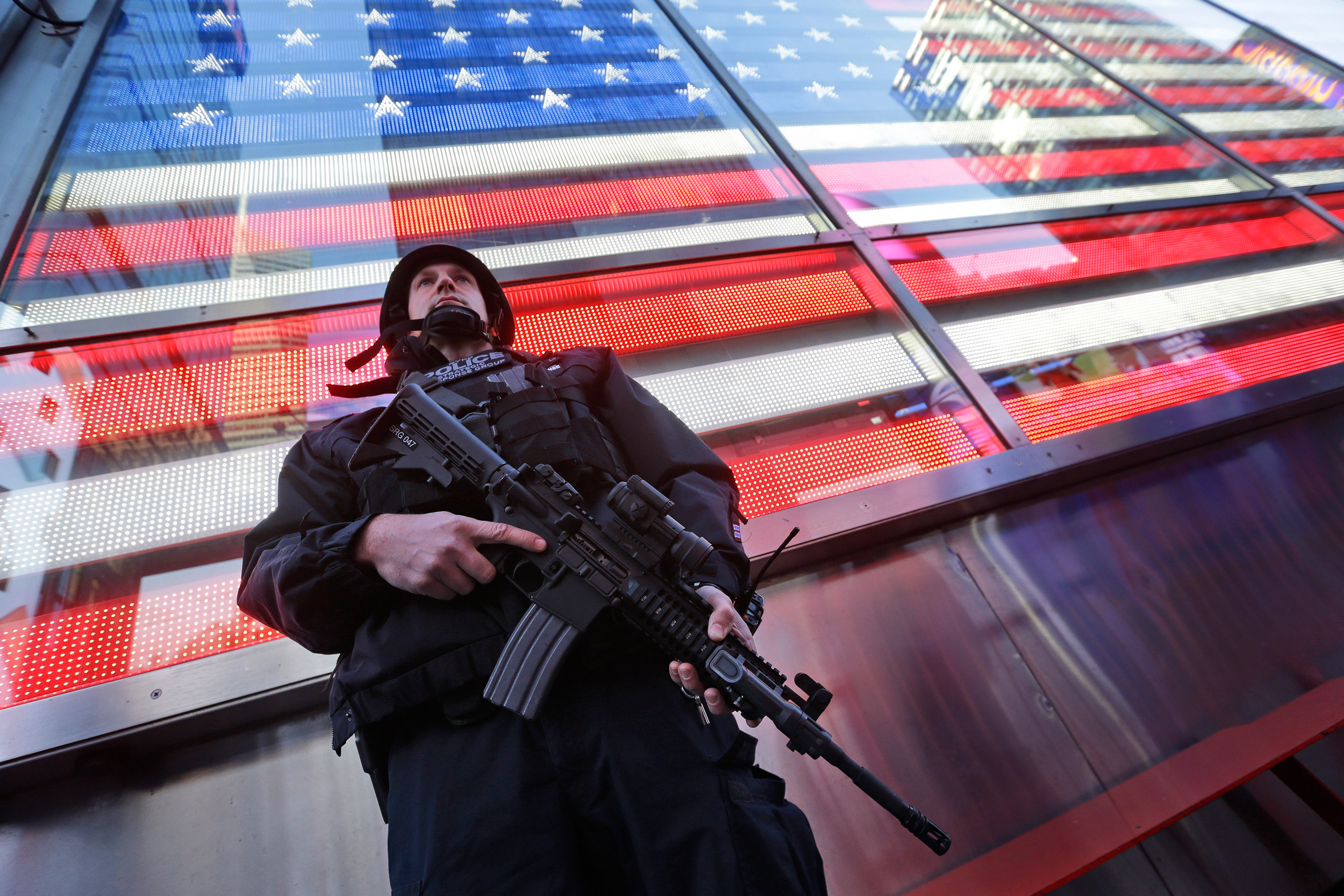 A heavily armed New York City police officer with the Strategic Response Group stands guard at the armed-forces recruiting center in Times Square in New York City on Nov. 14, 2015 (Mary Altaffer—AP)