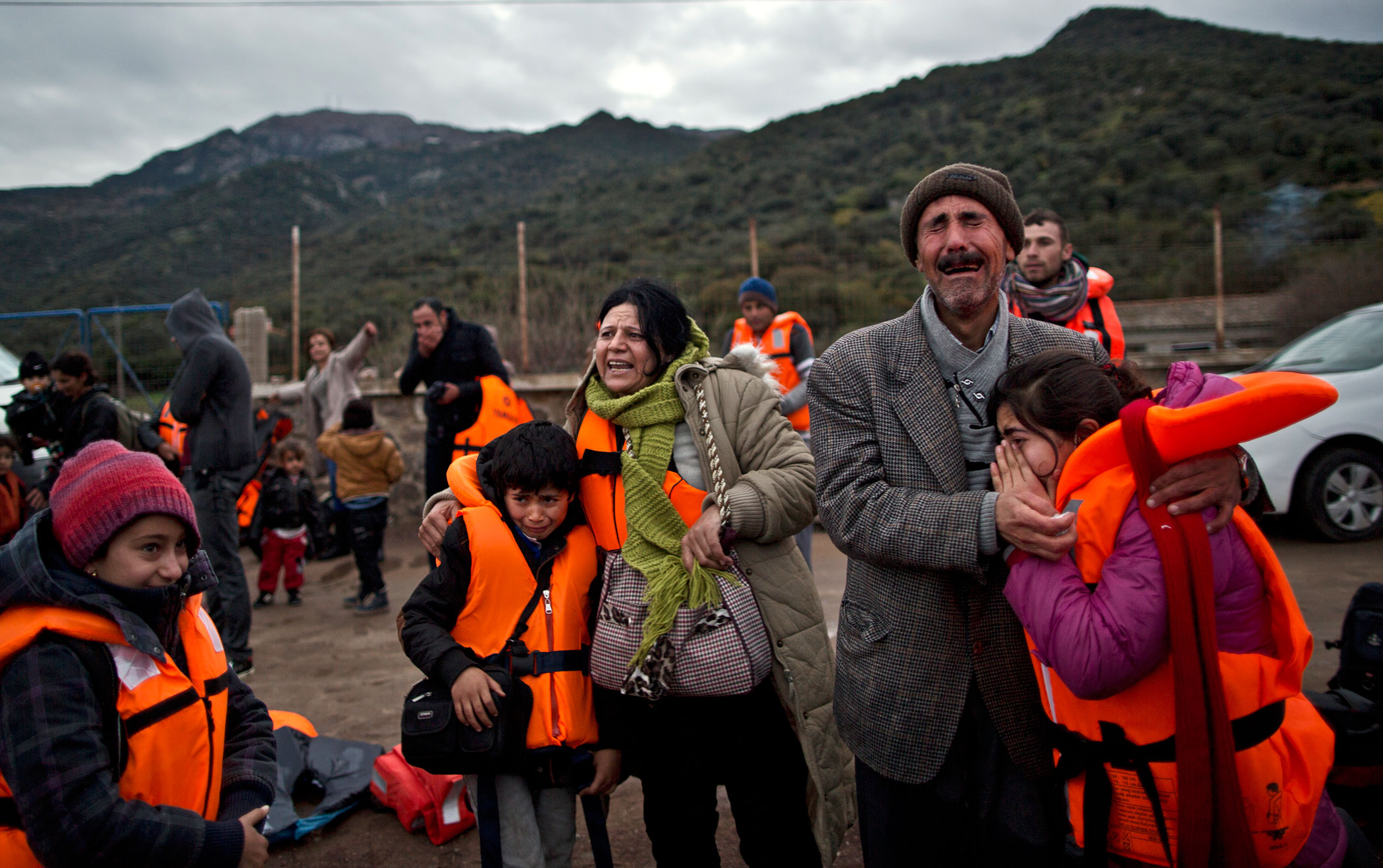 Yezidi refugee Samir Qasu, 45, from Sinjar, Iraq, and his wife Bessi, 42, cry while embracing two of their children, Dunia, 13, and Dildar, 10, shortly after arriving on a vessel from Turkey to the Greek island of Lesbos, Dec. 3, 2015.