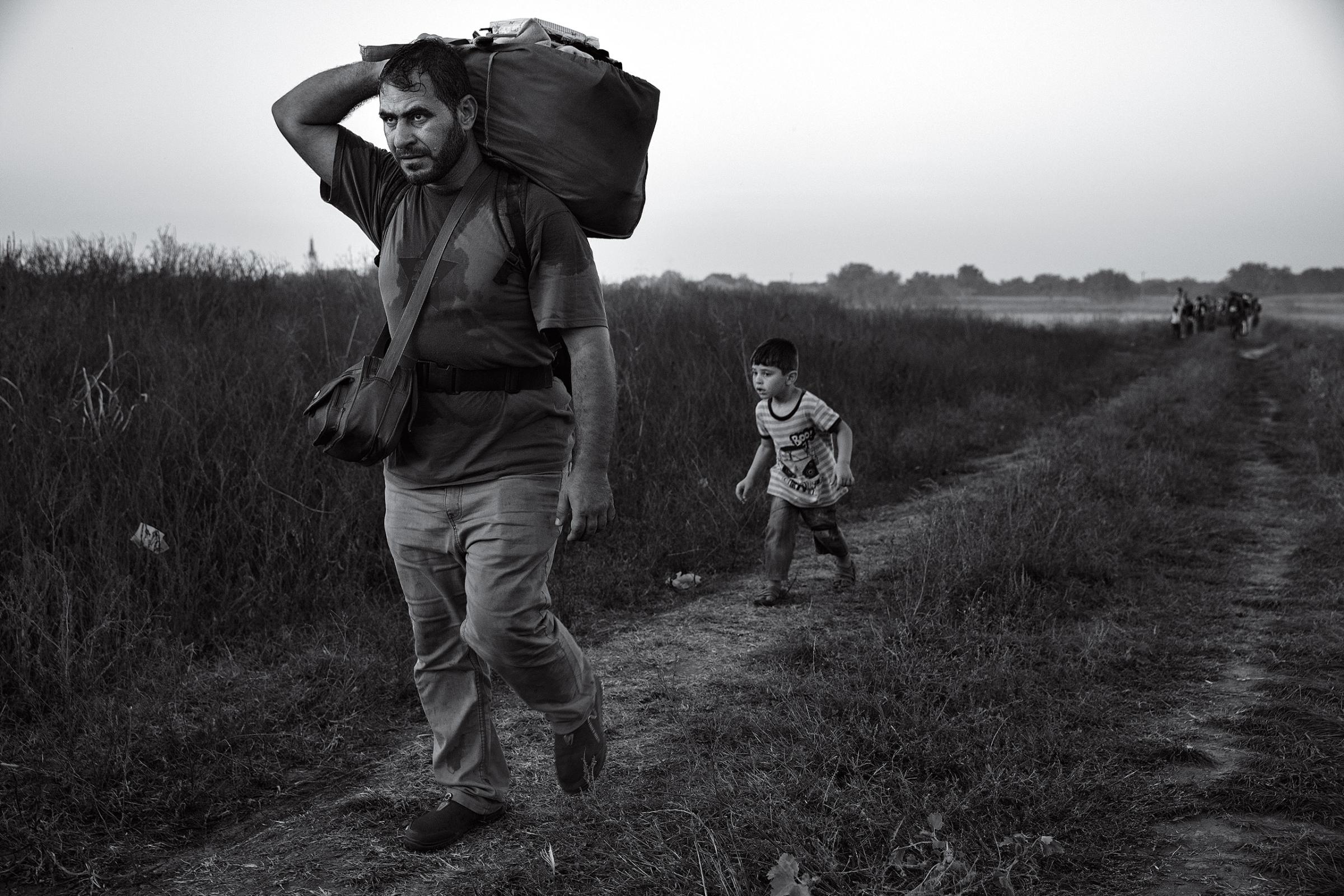 Refugees mainly from Syria, but also Afghanistan, Iraq and parts of Africa making their way across Europe. Walking from Serbia across border to Croatia, where they gathered at Tovarnik to board trains and buses to be transported to either Hungary or Slovenia, then to be taken to border with Austria and onward. by James Nachtwey