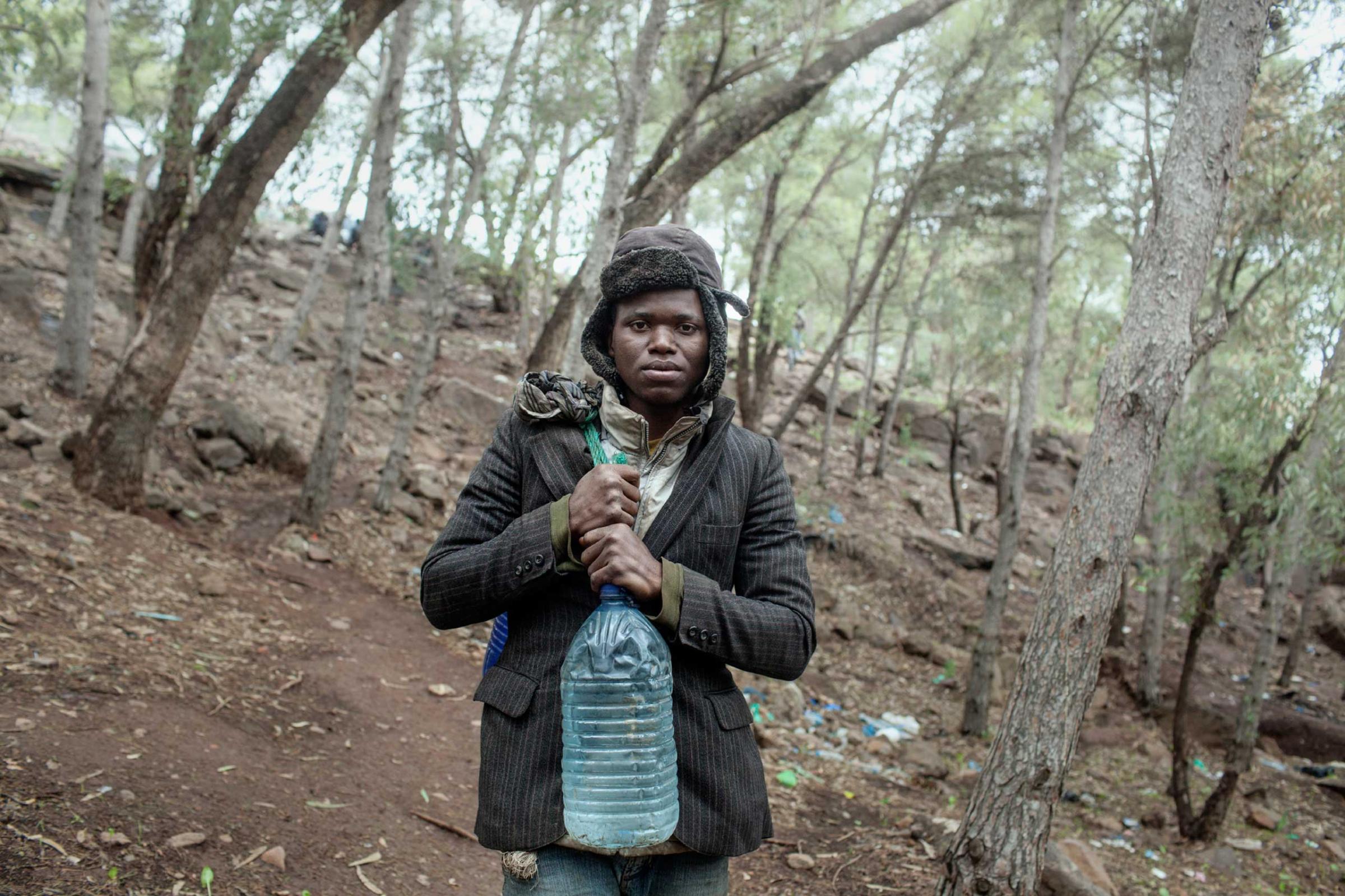 Portrait of a sub-Saharan migrant on Mount Gurugu, Nador, Morocco in 2012, where hundreds of African immigrants living in precarious conditions waited for the opportunity to cross the fence into Melilla, Spain. The enclave's border had heavy security, including a six-meter tall double fence with watchtowers.
