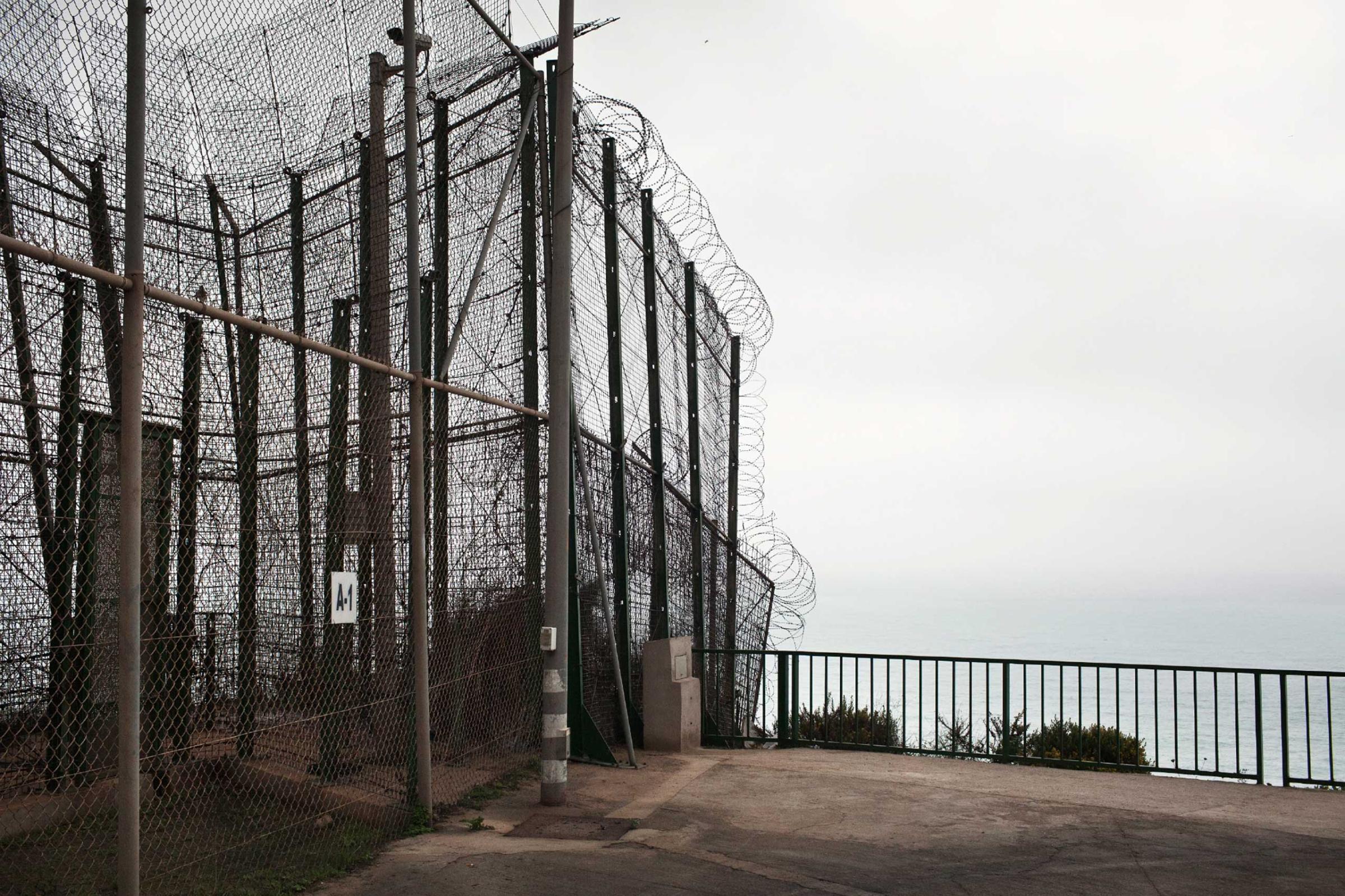 The border fence that divides the Moroccan city of Nador from the Spanish enclave of Melilla, in Northern Africa, 2012. The security fence which runs the full length of the border has heavy security, including a 19-foot-tall double fence with watchtowers, and is as a popular crossing for sub-Saharan migrants hoping to illegally reach Spain.
